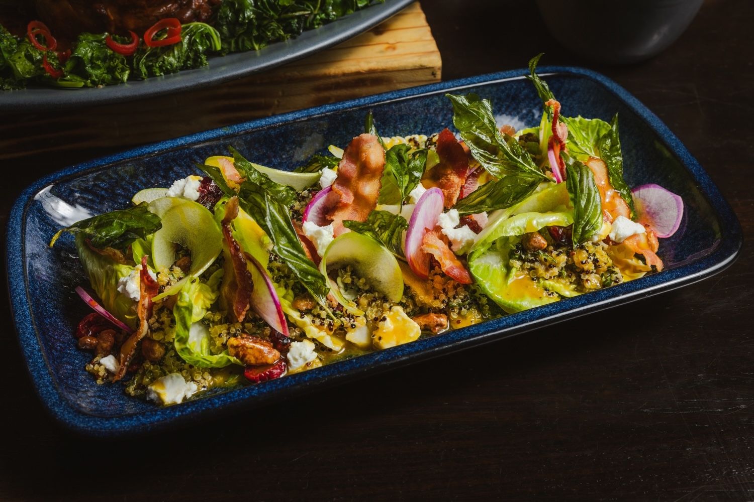 A blue dish with grains and vegetables.