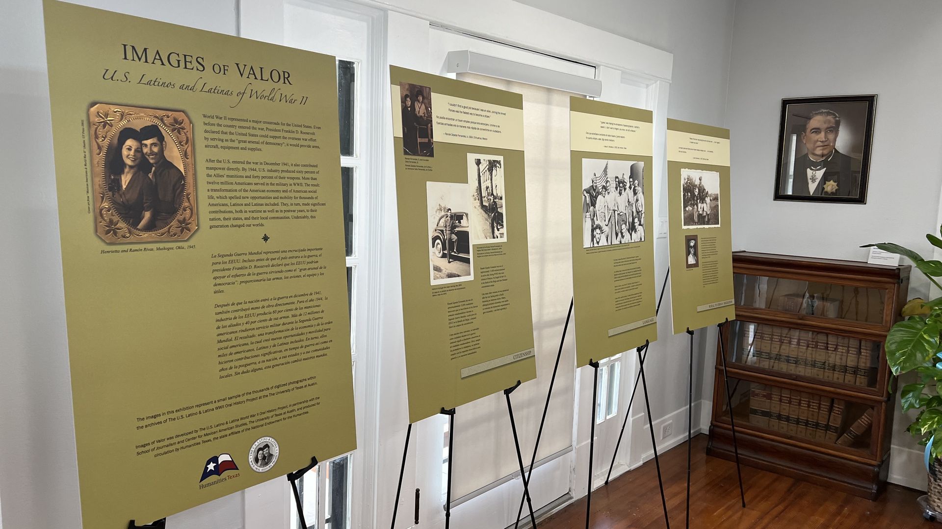 Four exhibit panels are propped up in a brightly lit room. 