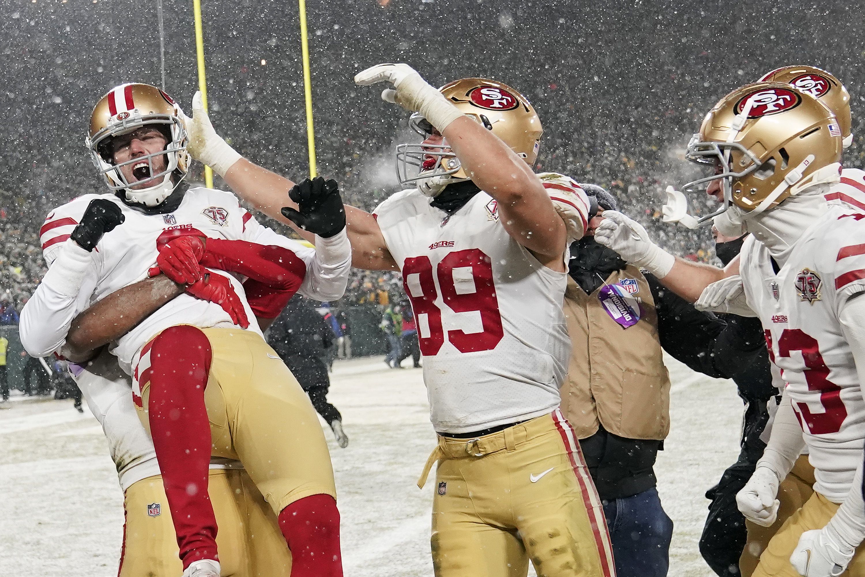 Picture of football players celebrating while it's snowing