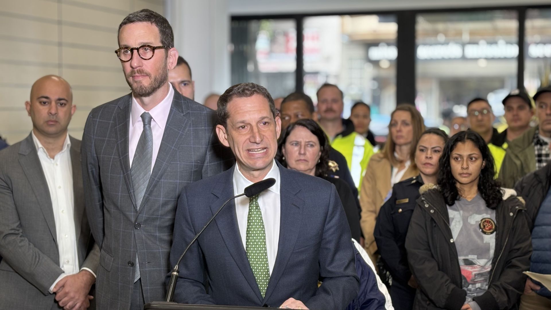 San Francisco Mayor Daniel Lurie speaks alongside state Sen. Scott Wiener at a press conference on illegal street vending.