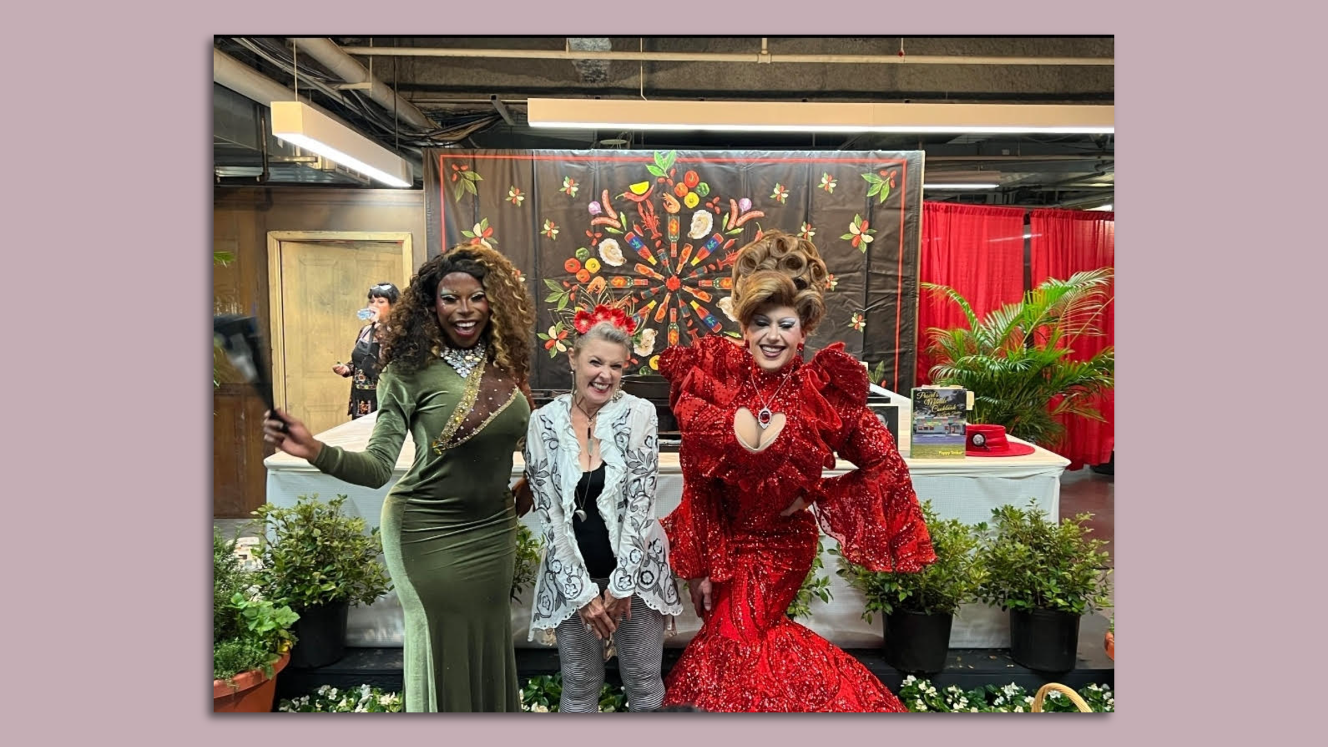 Poppy Tooker smiles in a photo with drag queens Leveau Contraire and Debbie with a D.