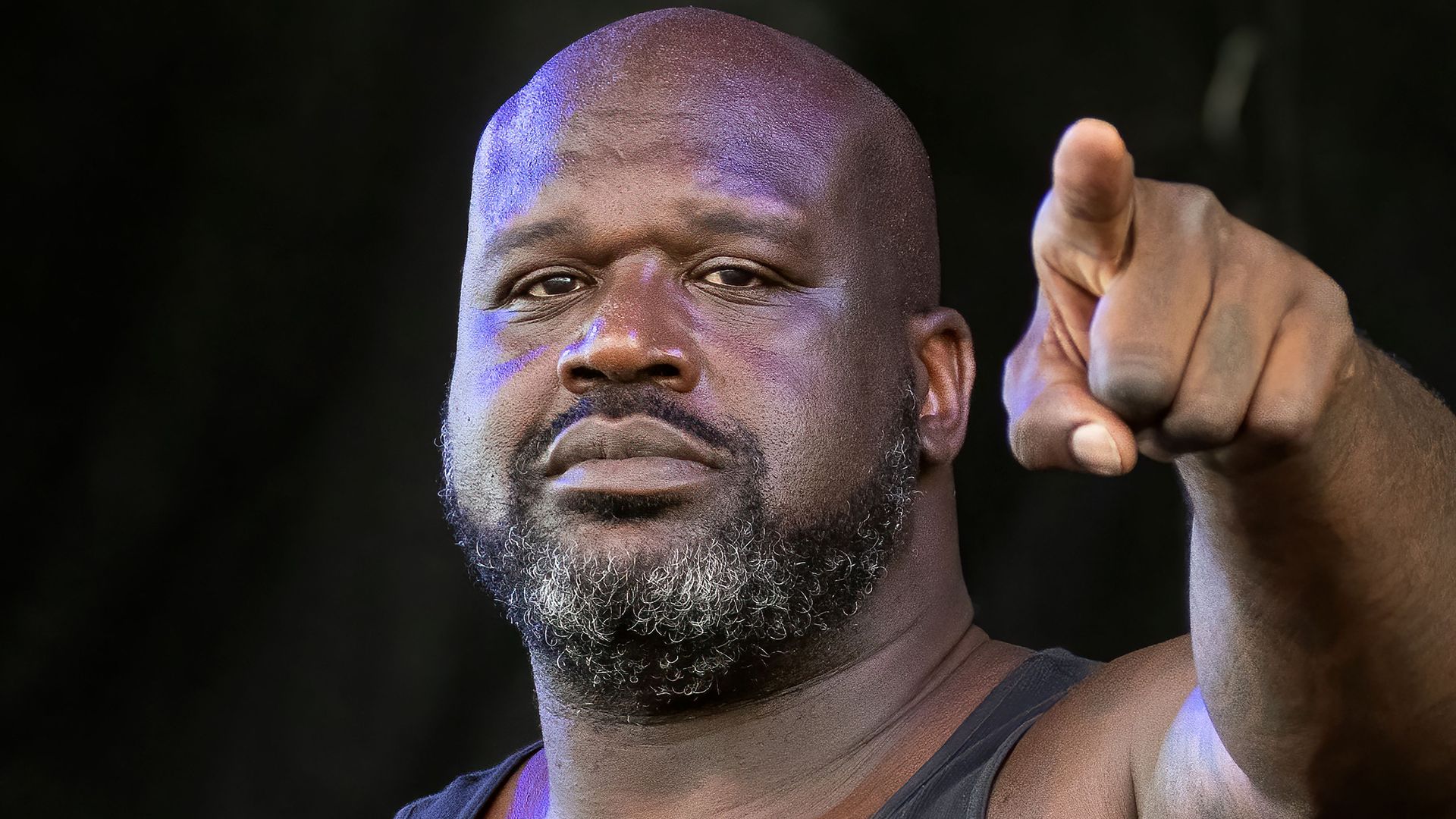 Shaq, with a beard, pointing at the camera