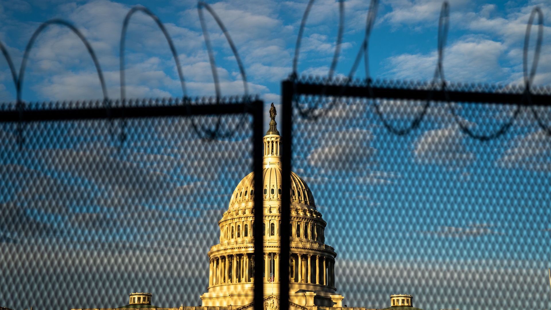 The US Capitol behind a fence.