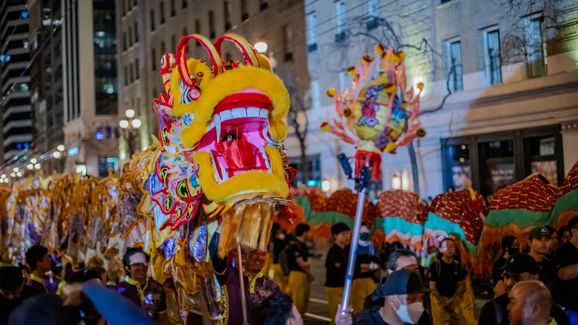 Photo of dancers holding up a dragon costume