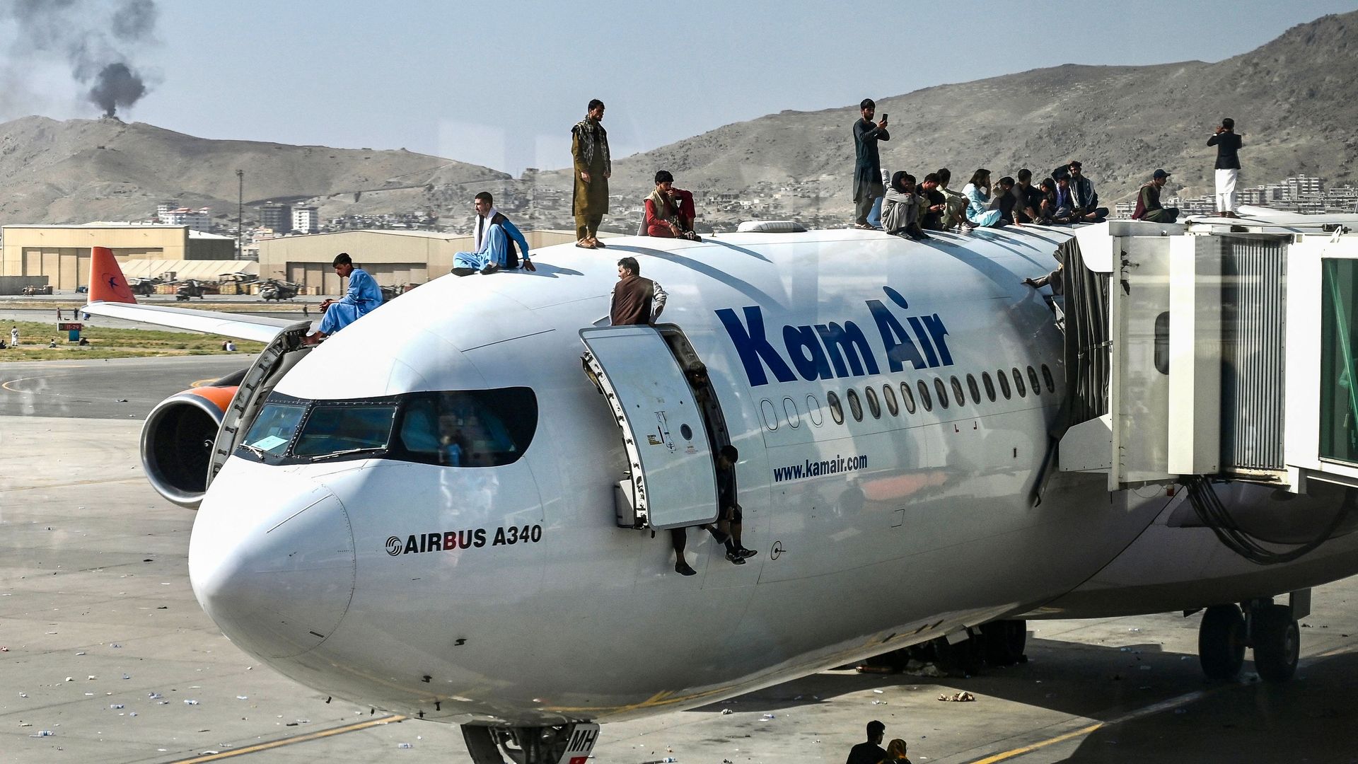 People standing on a jet at the Hamid Karzai International Airport in Kabul on Aug. 16.