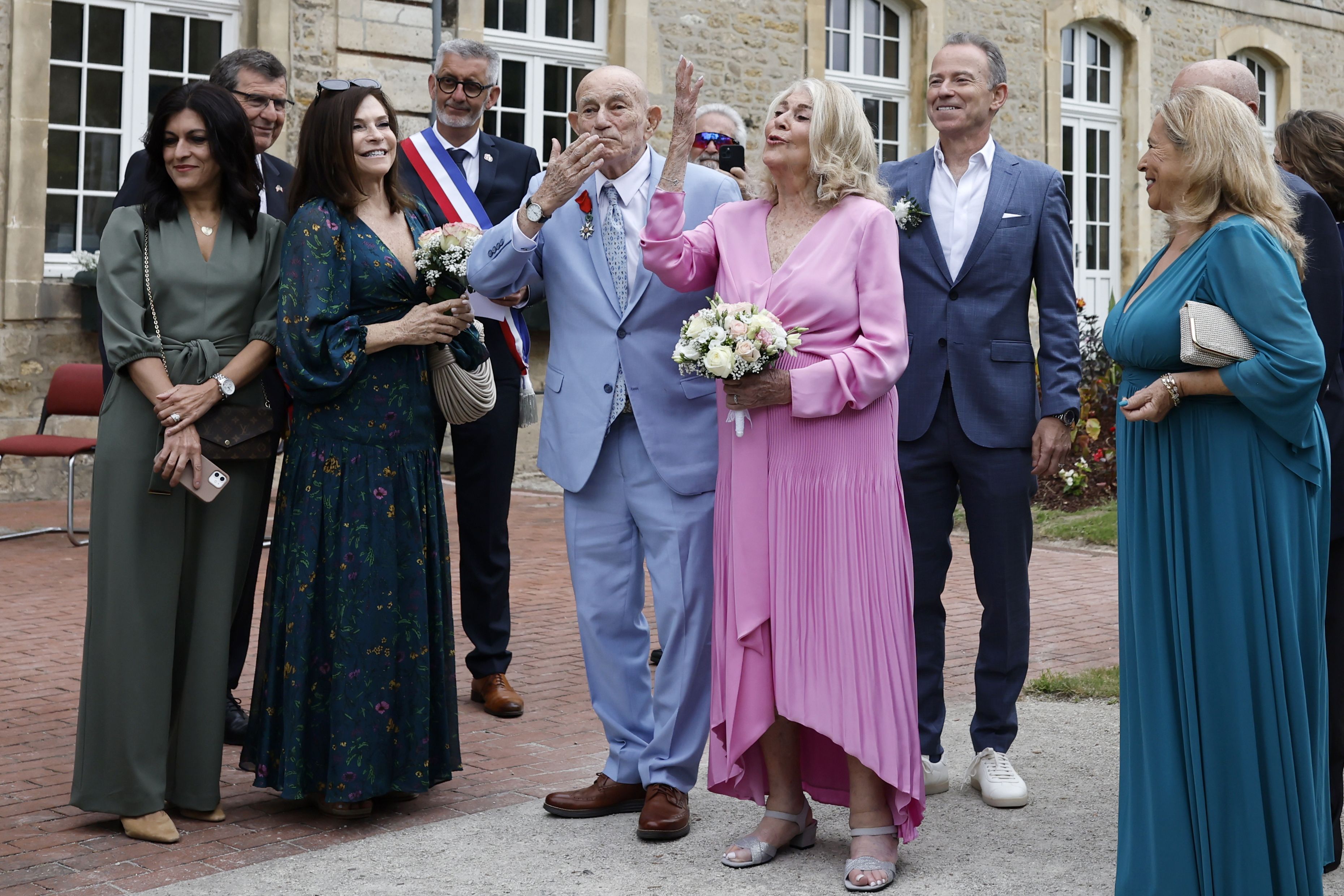 US WWII veteran Harold Terens, 100, center left, and Jeanne Swerlin, 96, arrive to celebrate their wedding at the town hall of Carentan-les-Marais, in Normandy, northwestern France