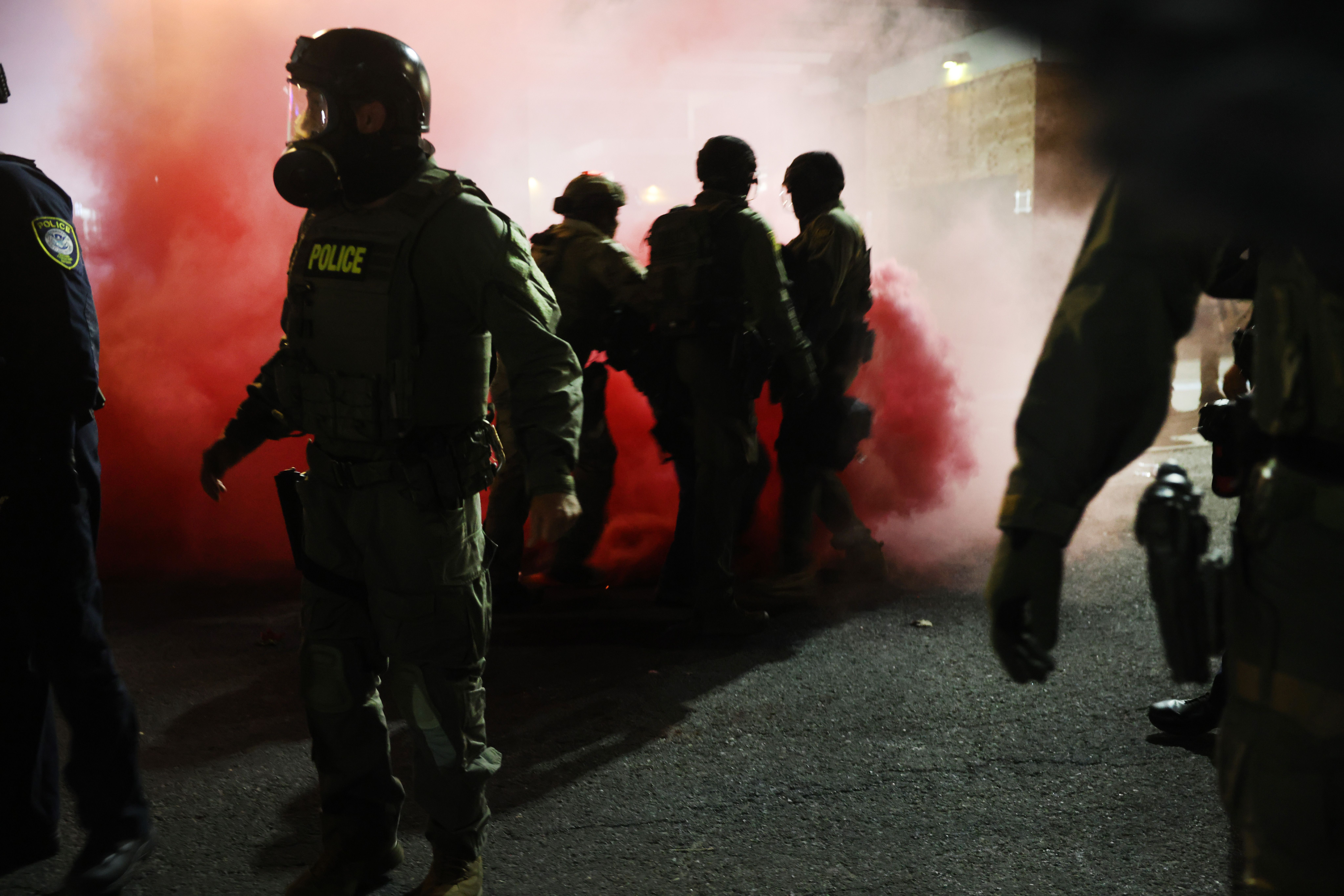 Federal agents, including members of the Department of Homeland Security, Border Patrol, and the police, attempt to keep protesters back outside a downtown U.S. Immigration and Customs Enforcement (ICE) facility on October 05, 2025 in Portland, Oregon. The facility has become a focal point of nightl