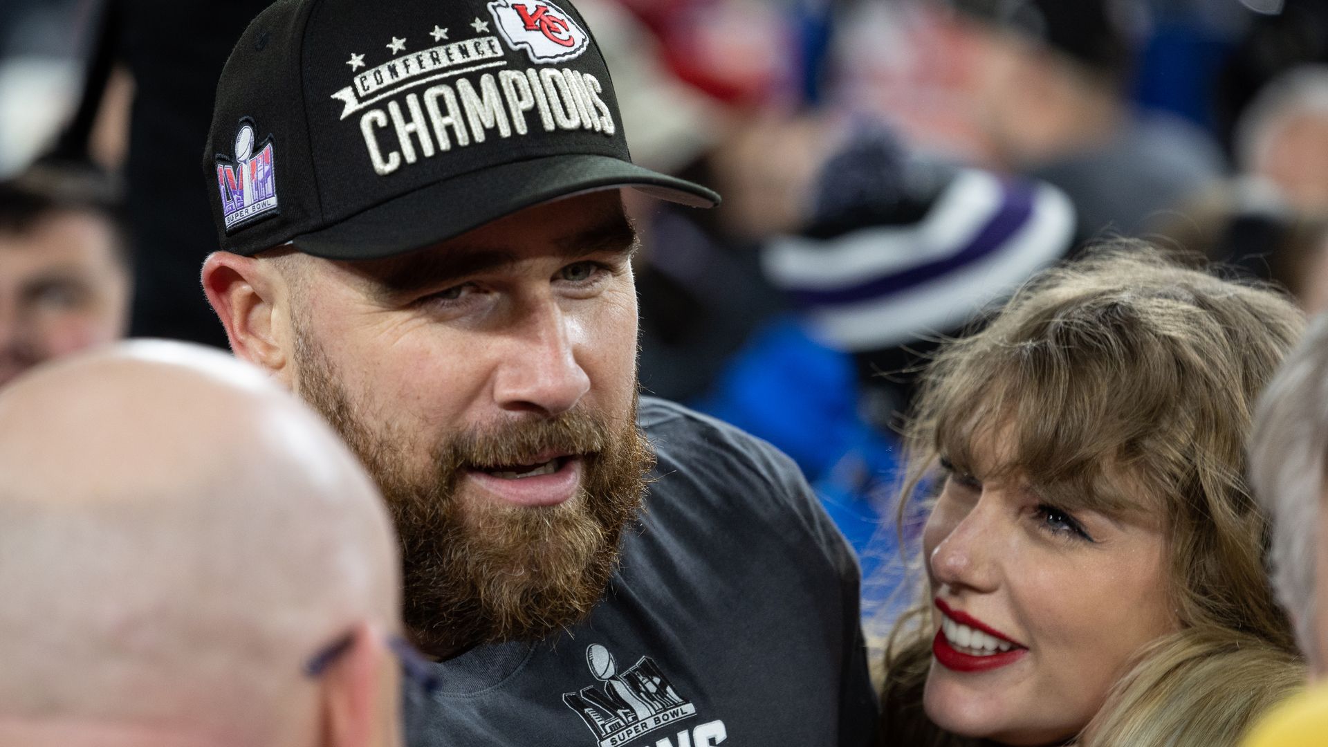 Taylor Swift and Travis Kelce hold each other on the field after his team clinched a spot in the Super Bowl