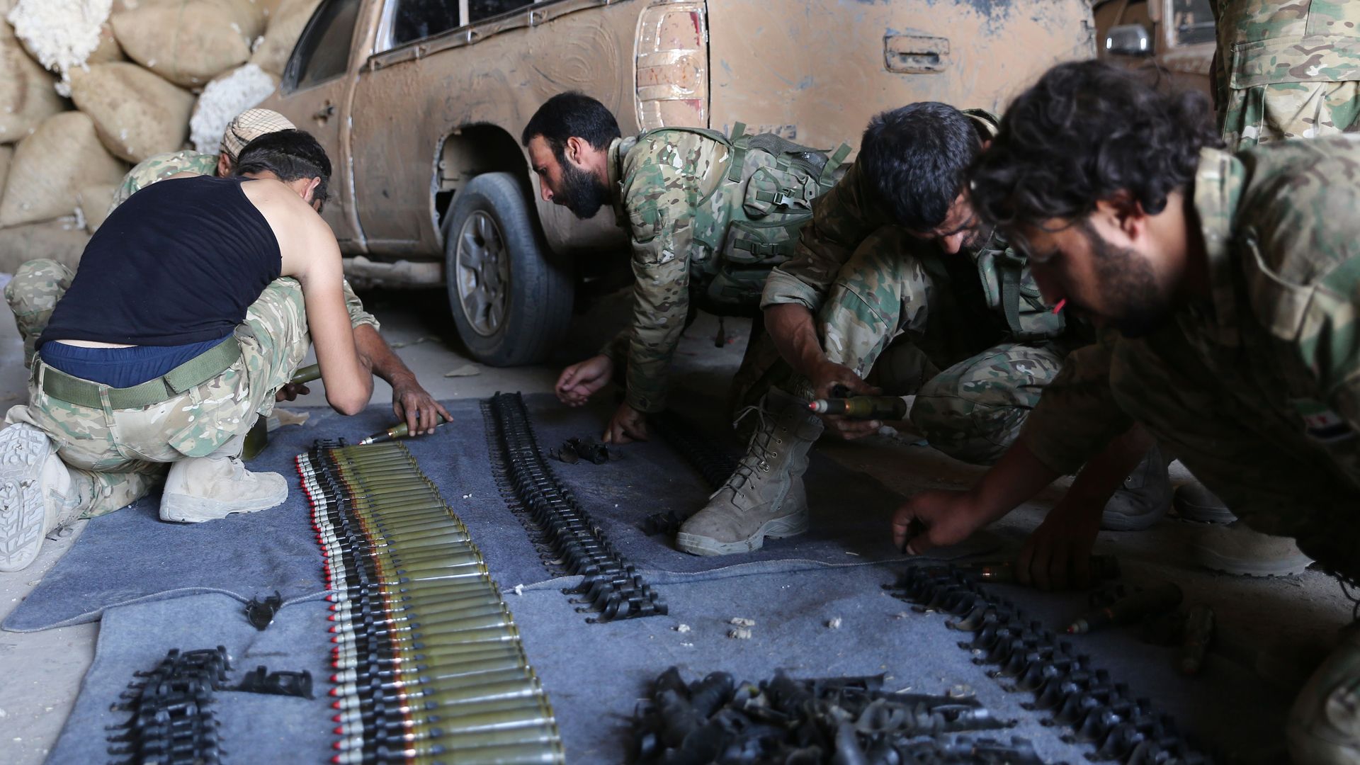 Turkish backed forces reload ammunition in Syria