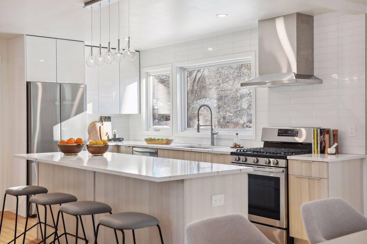 bright white modern kitchen with stainless steel appliances