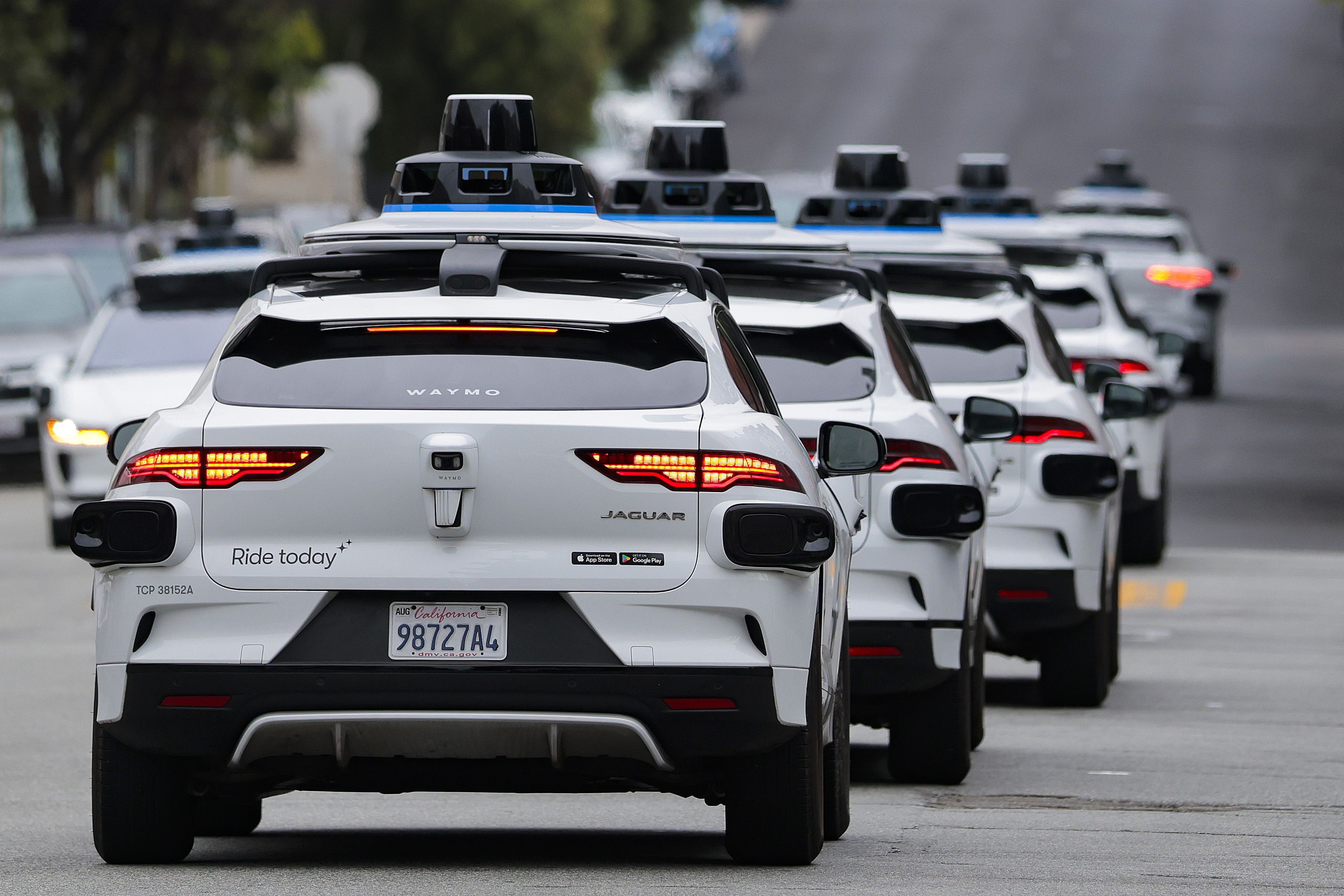 A line of Waymo robotaxis navigate San Francisco earlier this month.