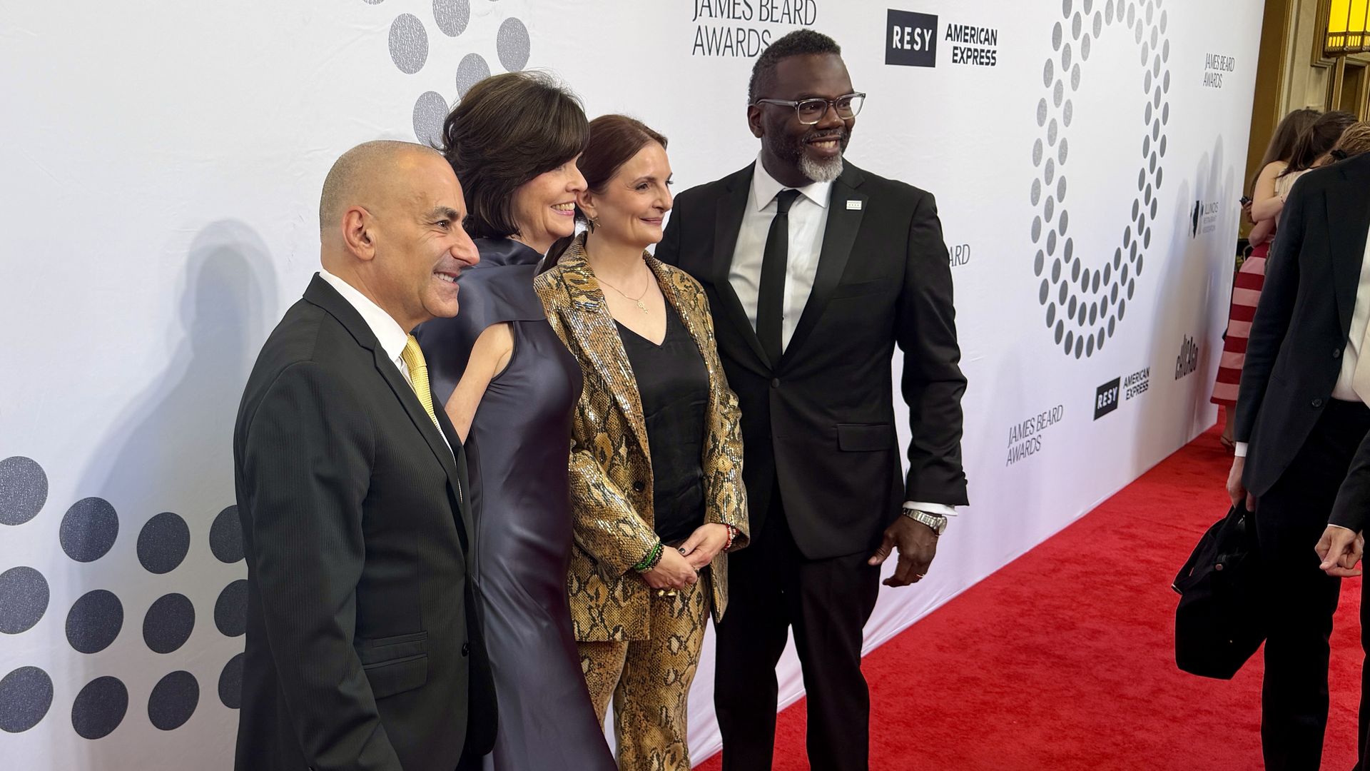 People standing on a red carpet at a gala
