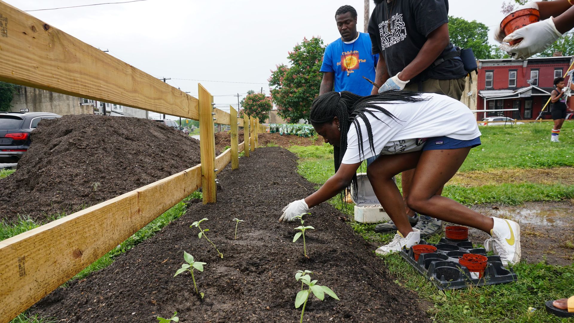 A young girl plants at a community garden in Southwest Philadelphia.