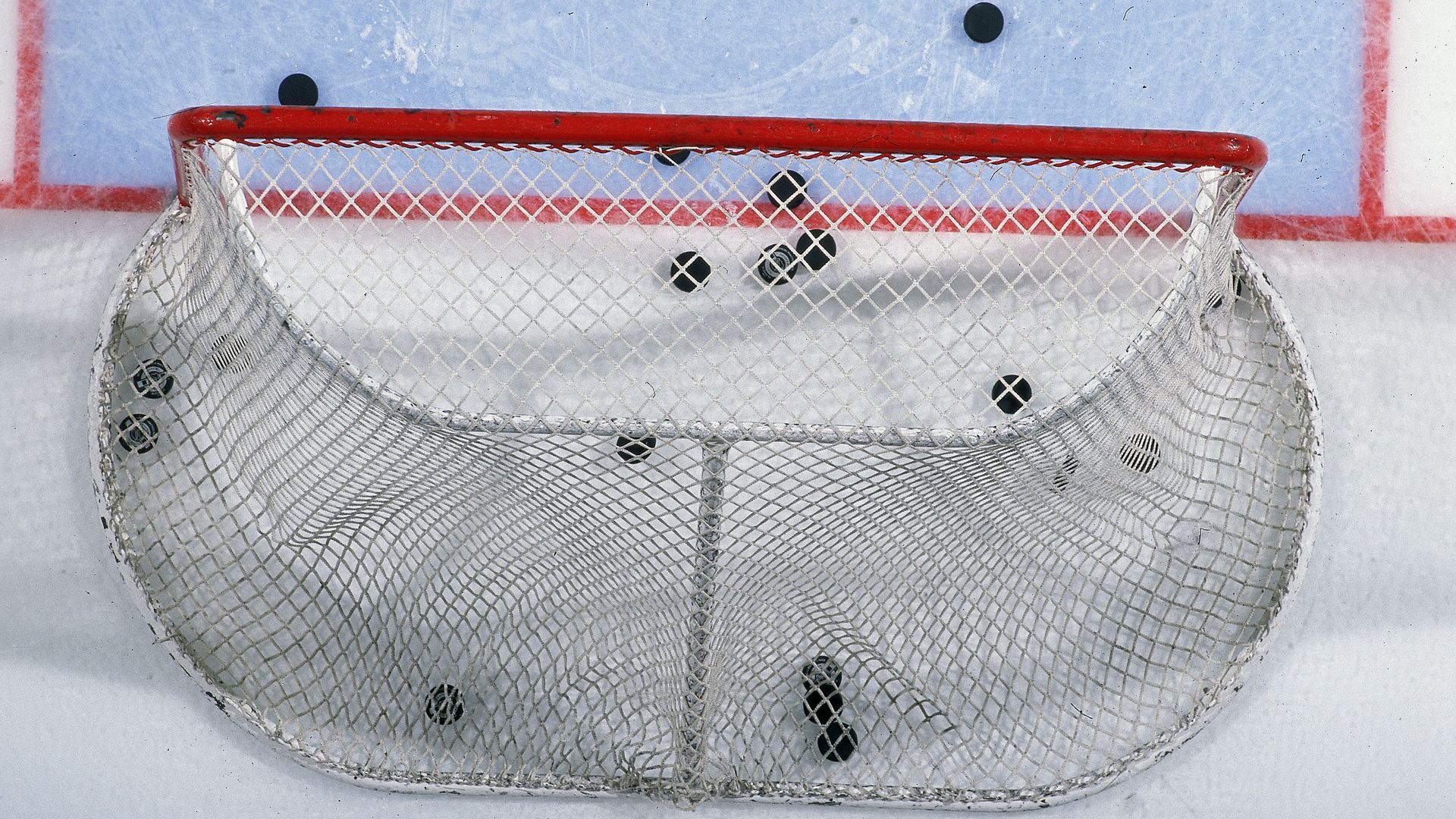 hockey goal with pucks in it