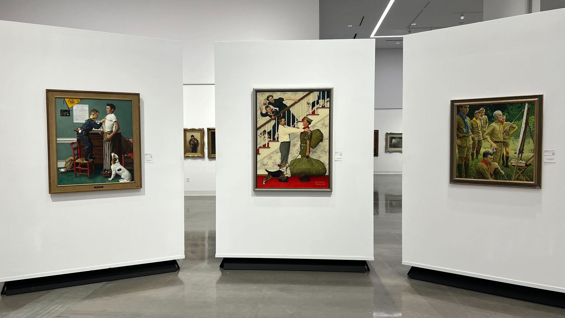 Three artworks hanging in a gallery 