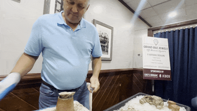 Man shows a shucked oyster
