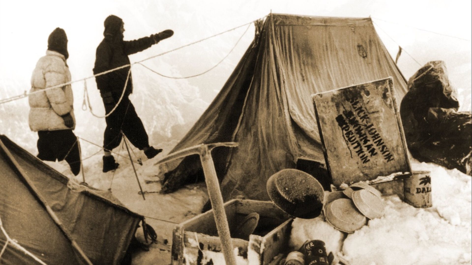 A black and white photo shows a tent in Nepal surrounded by snow during a 1957 search for the yeti.