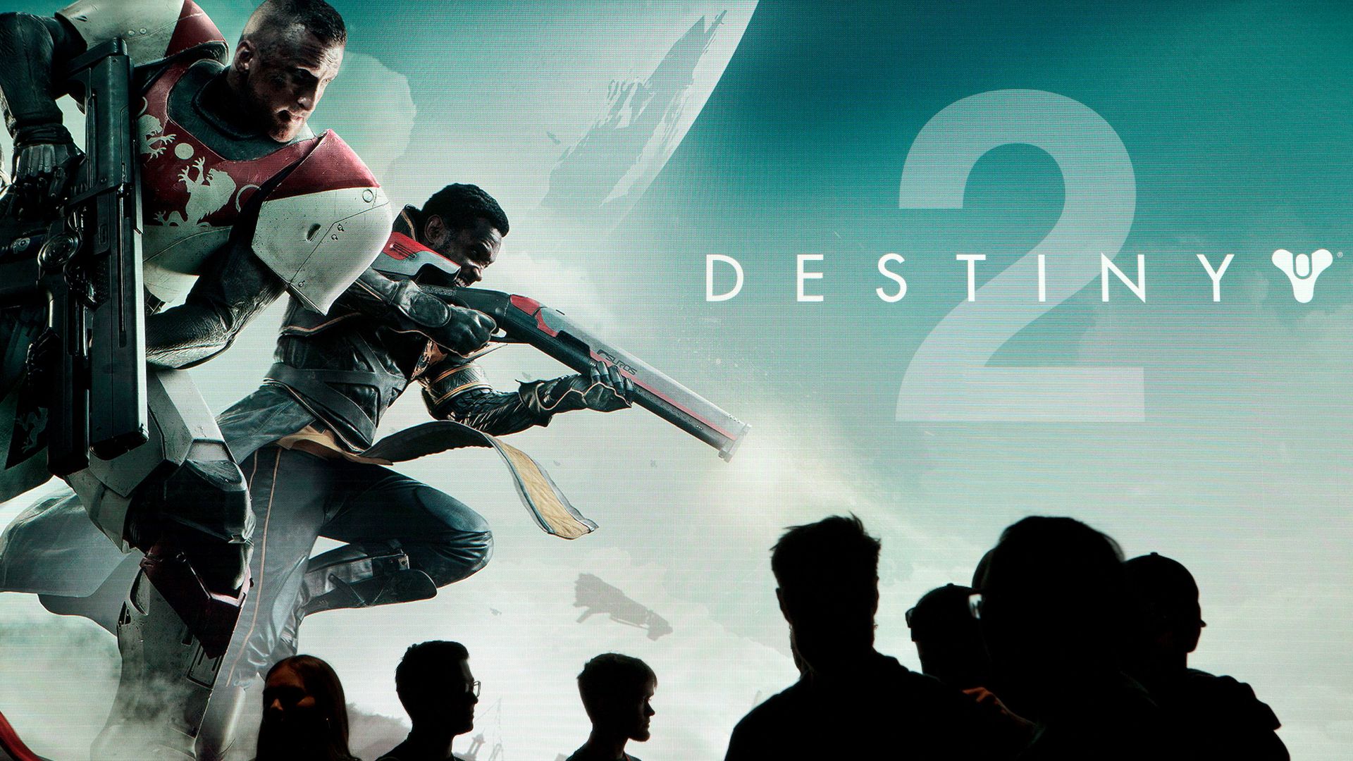Attendees walk past signage for the Activision Blizzard Inc. "Destiny 2" video game, developed by Bungie Inc.