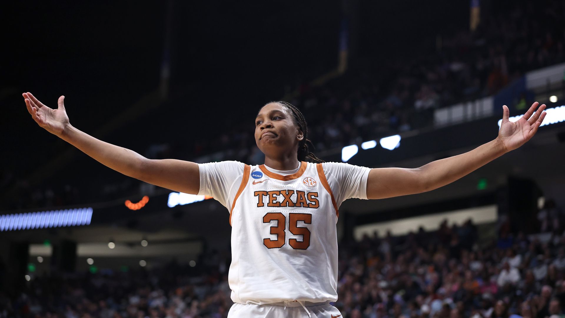 Madison Booker, her arms outstreched.