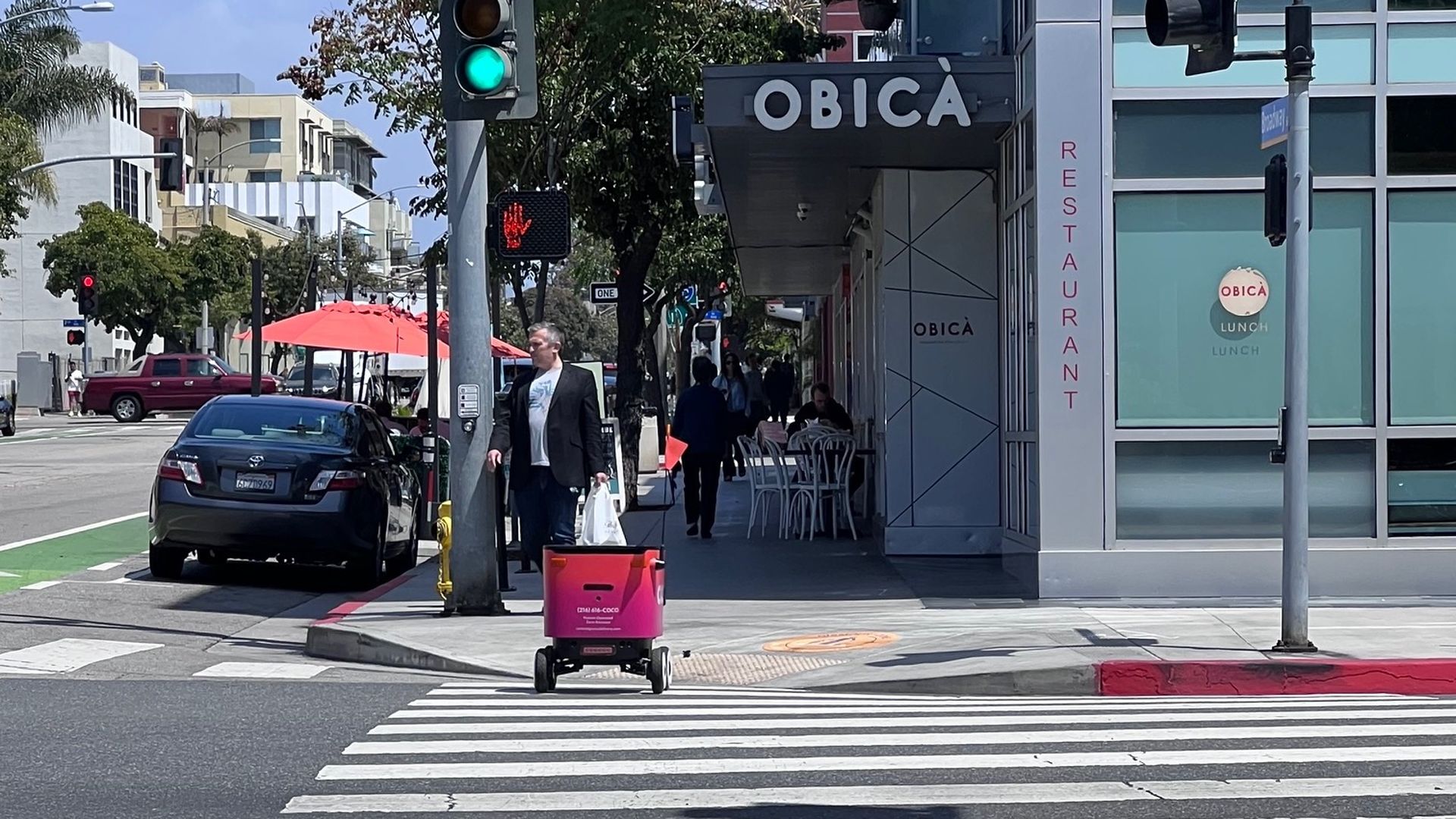 A delivery robot crosses the street