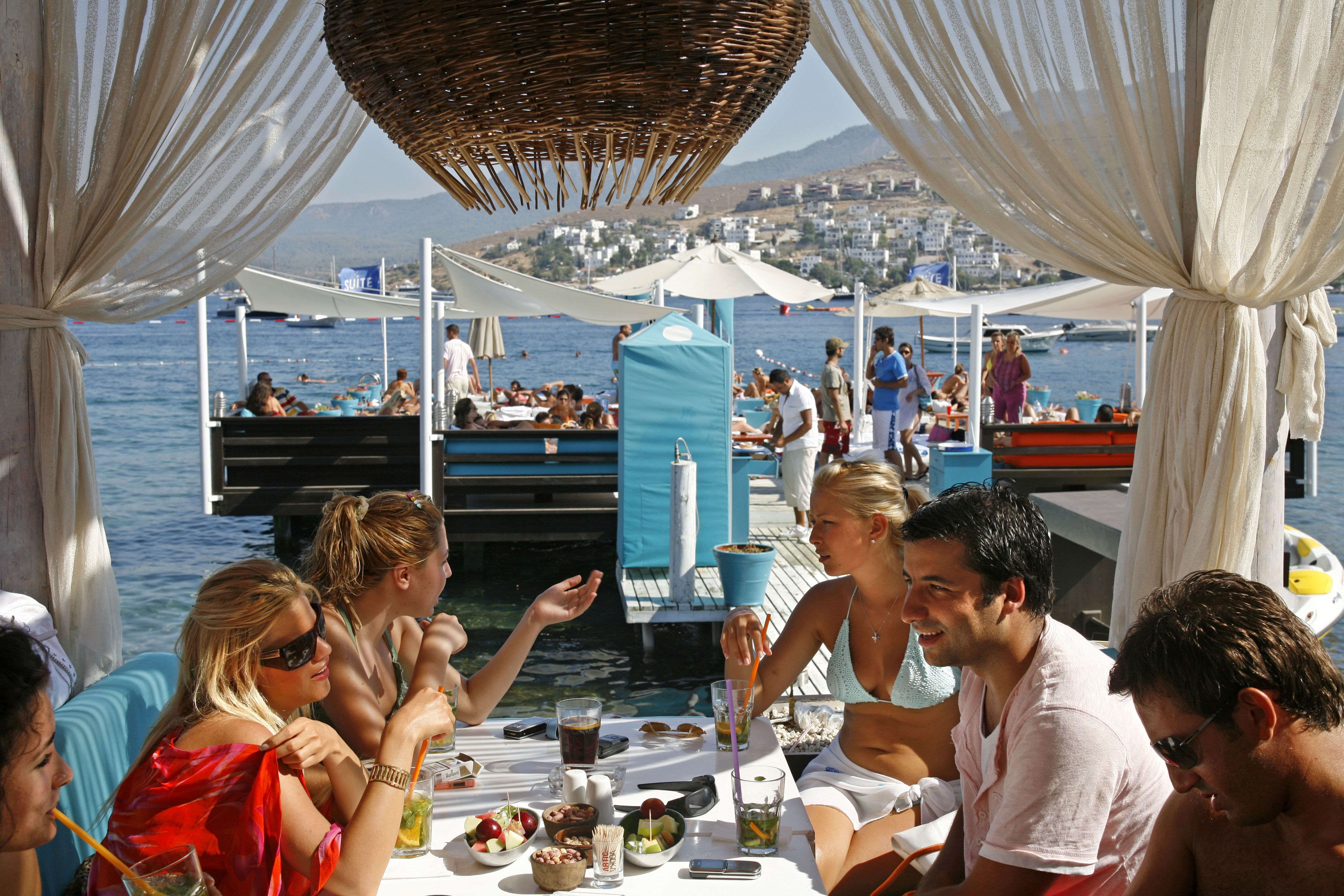 A group of diners at a beachside restaurant