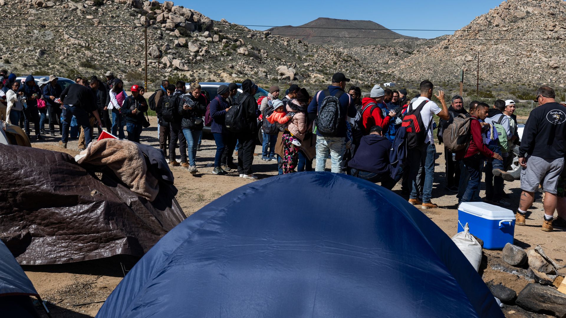 Migrants arrive at a makeshift camp after crossing the nearby border with Mexico near the Jacumba Hot Springs 