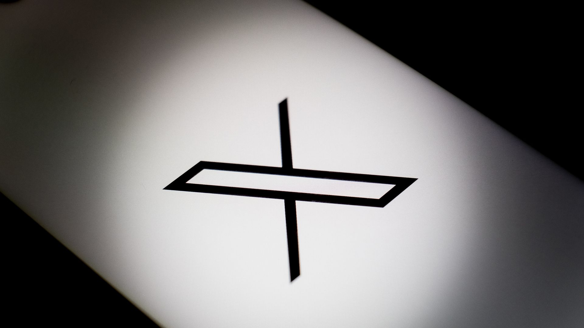 The X logo is being displayed on a smartphone screen 