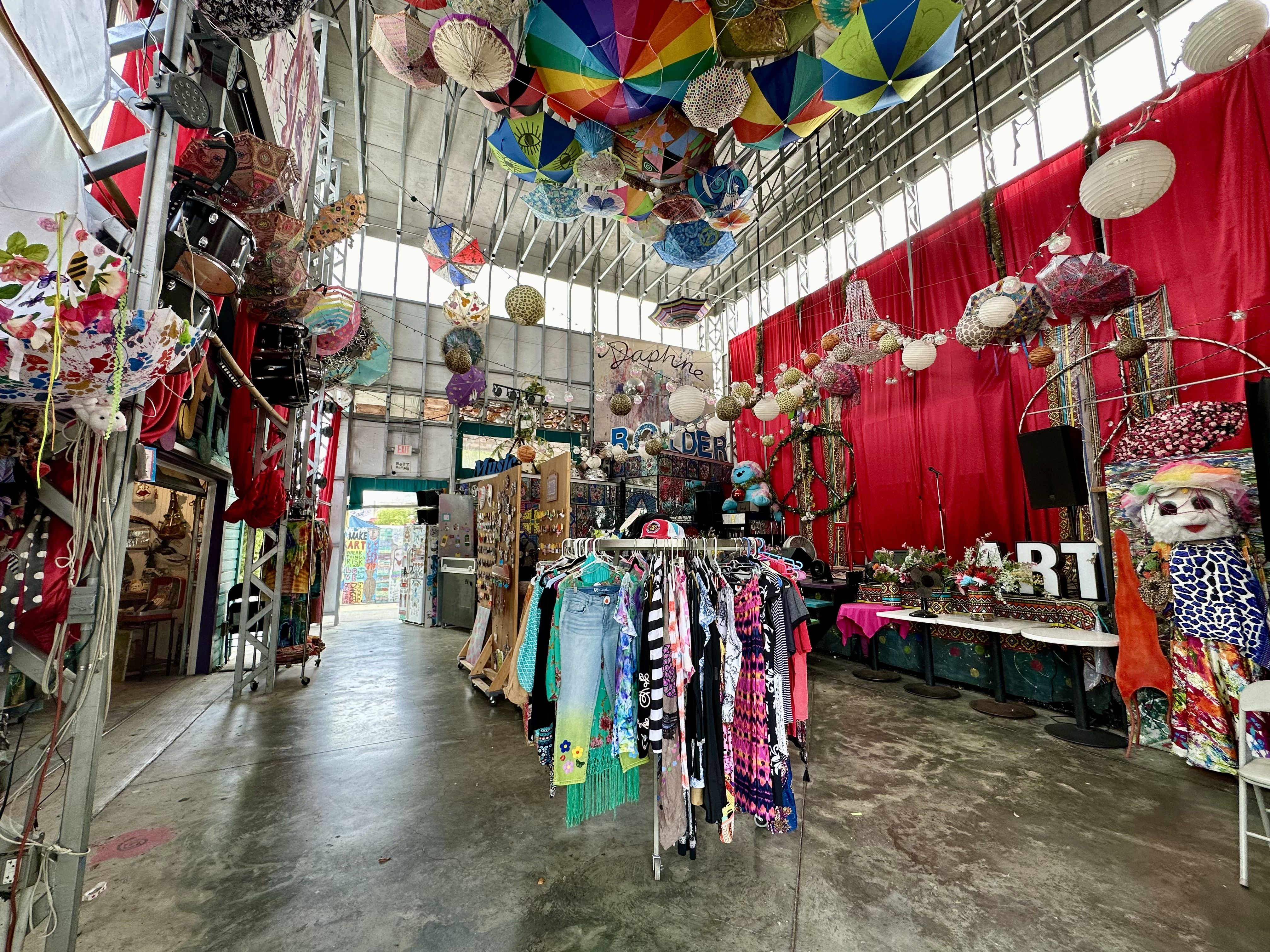 colorful clothes racks and a stage inside SHAMC