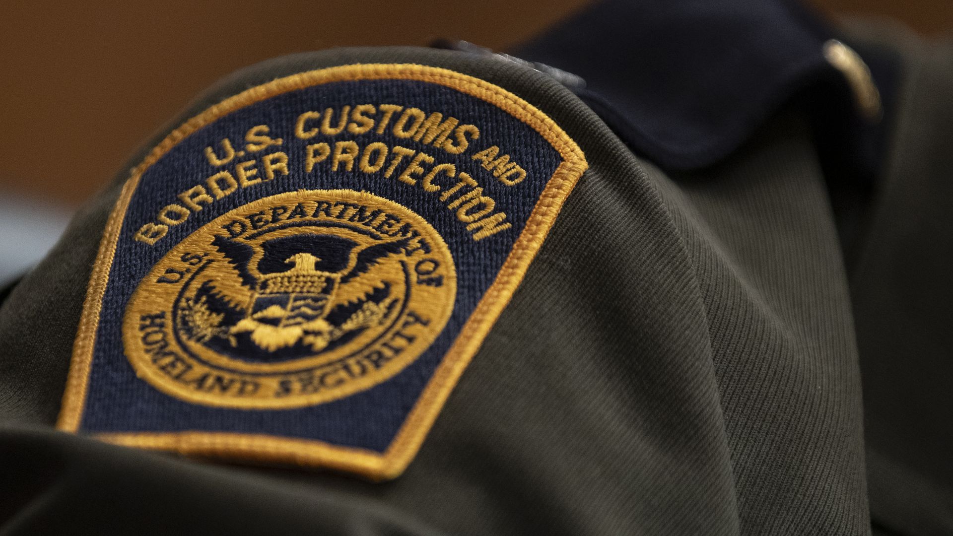 A U.S. Customs and Border Protection patch on the uniform