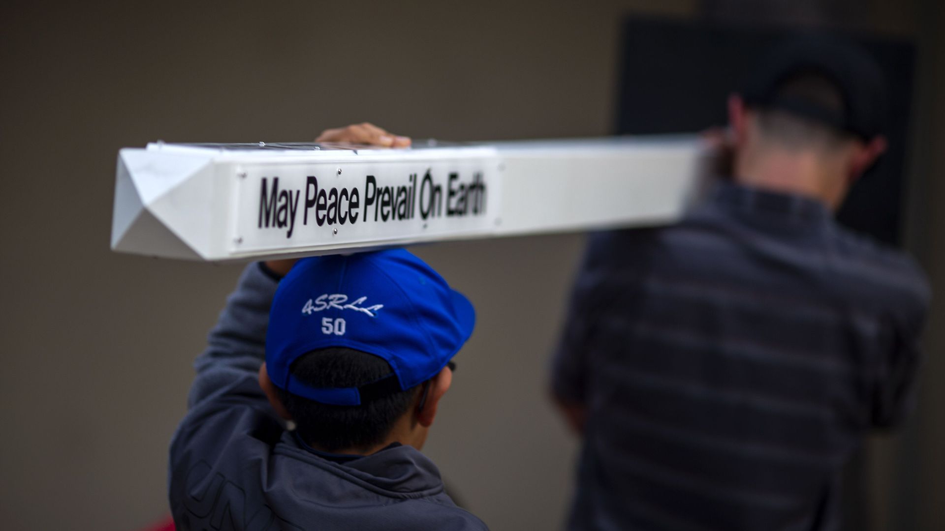 Man carrying peace pole
