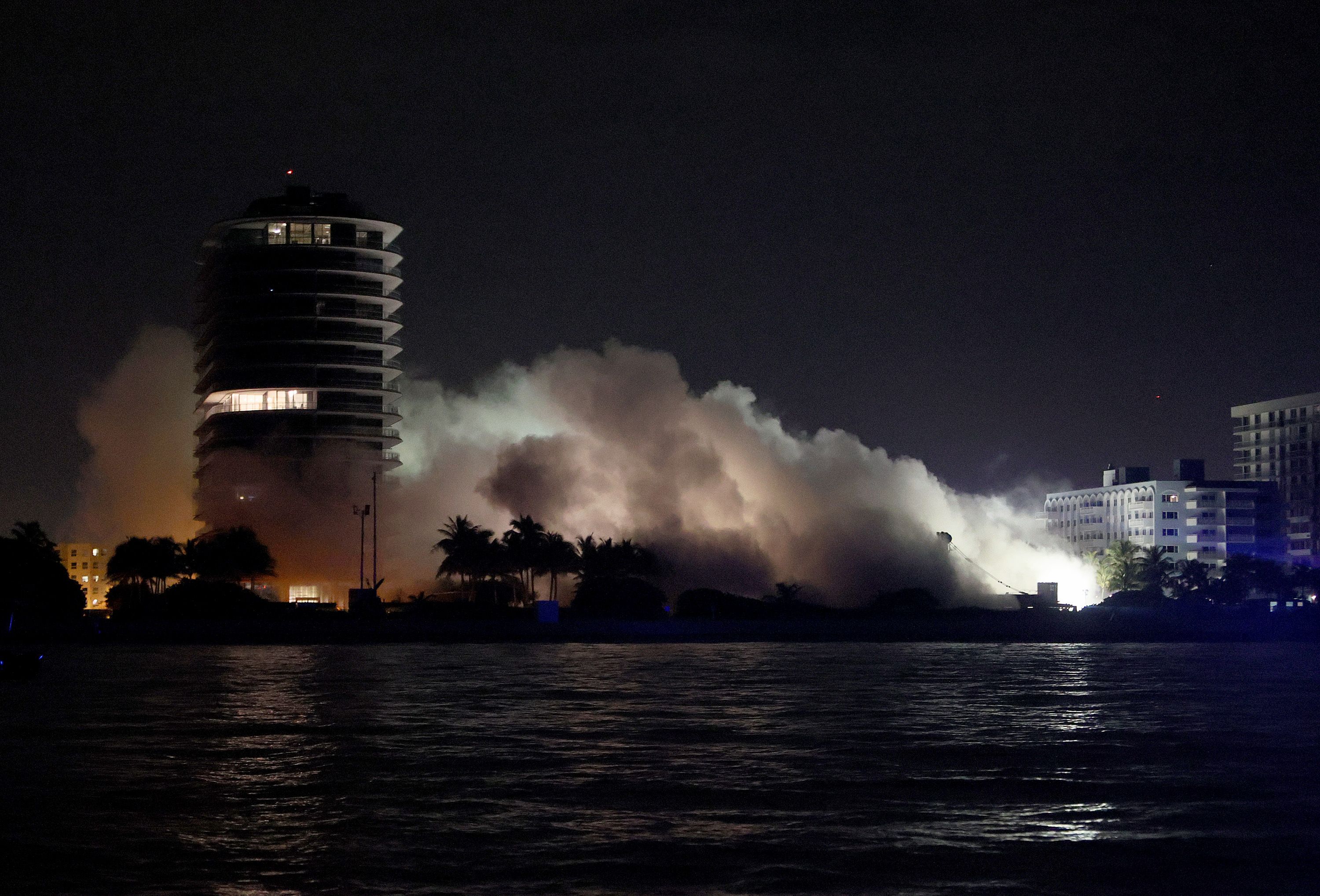 Smoke and dust linger in the air after the remaining part of Champlain Towers South fell in a controlled demolition on July 4, 2021 in Surfside, Florida. 