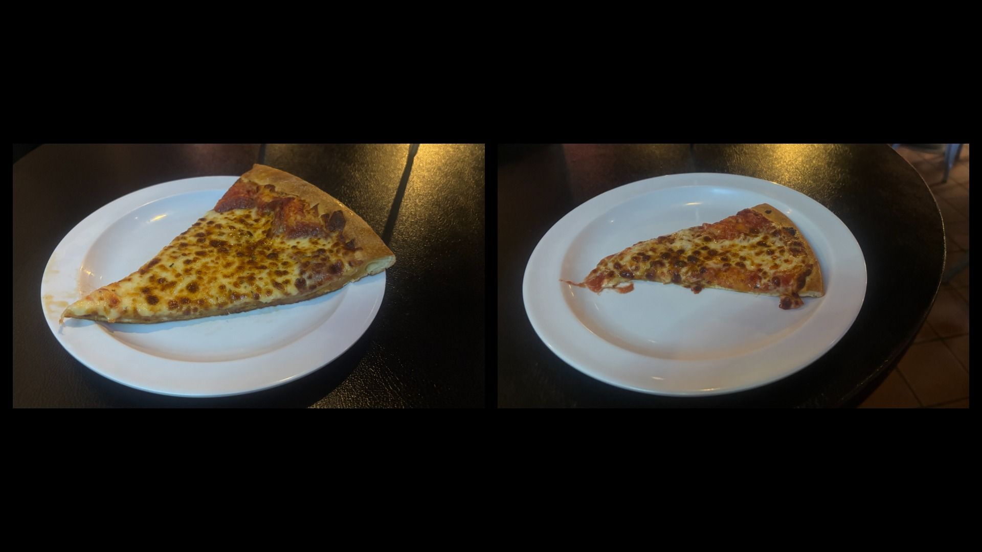 Two slices of cheese pizza on white plates placed on a dark table, with well-browned cheese and golden crusts visible on each slice.