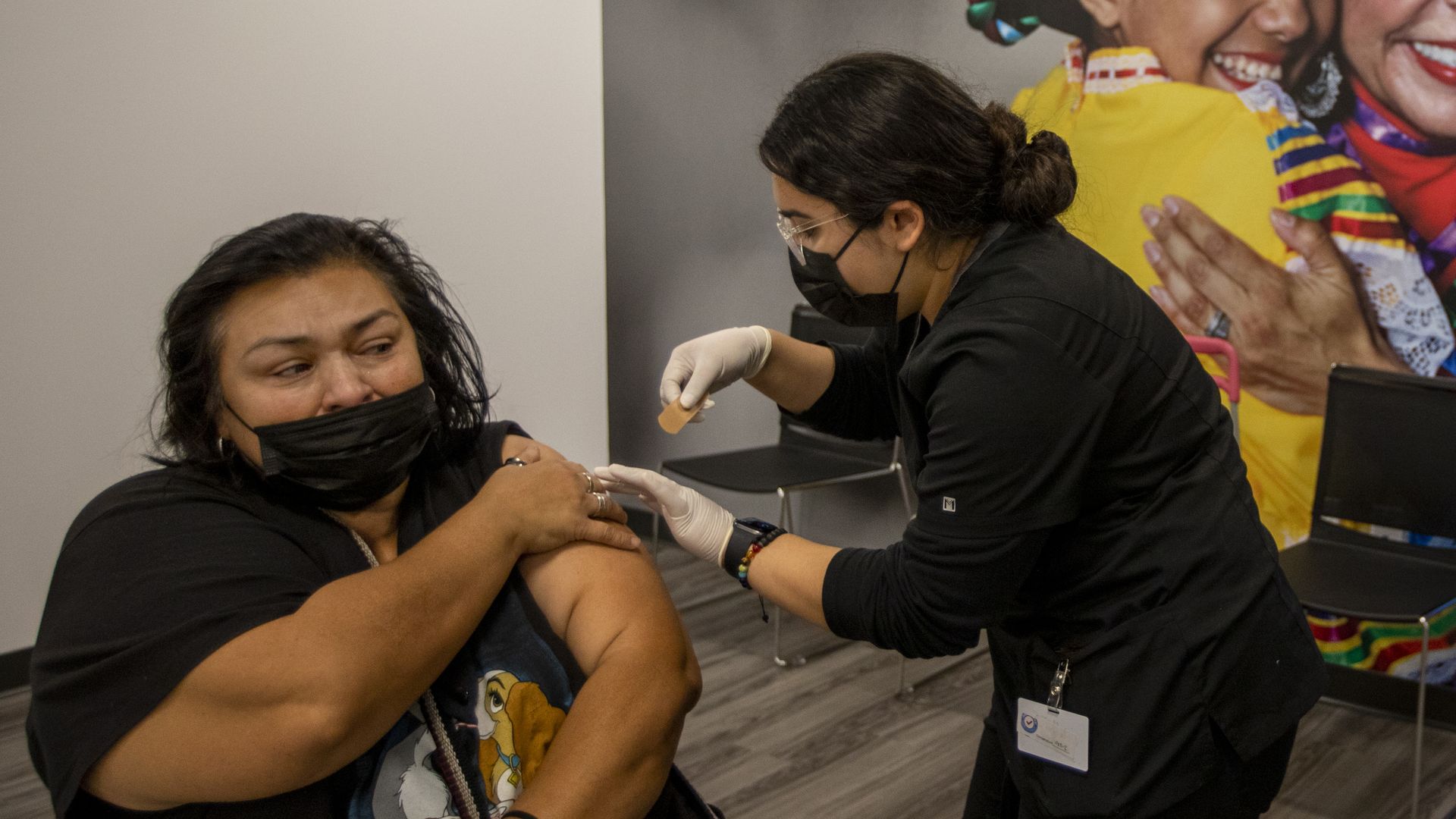 : Irene Michel, right, gives Santana Ruiz, left, a Covid-19 vacination.