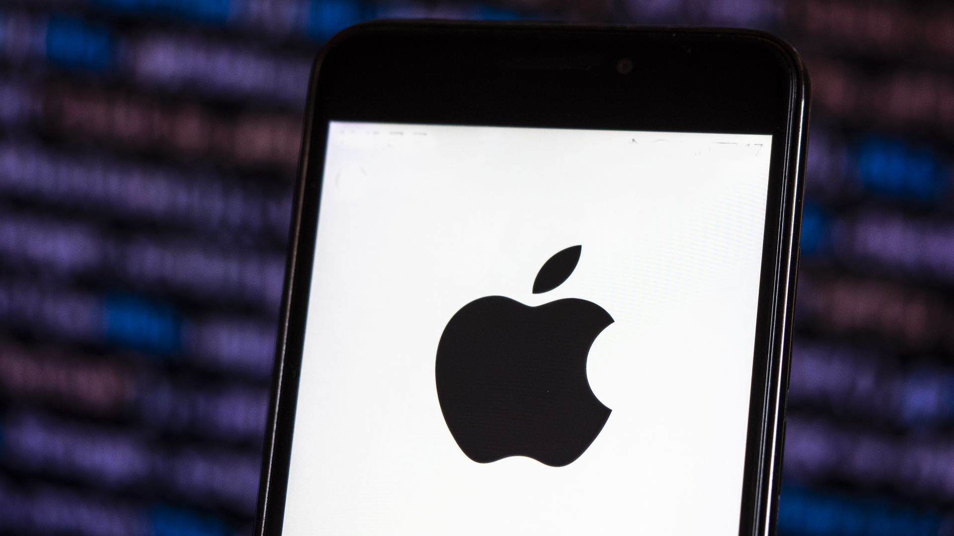 Apple logo seen displayed on a smart phone with a digital background. Apple's market capitalization exceeded $1 trillion.