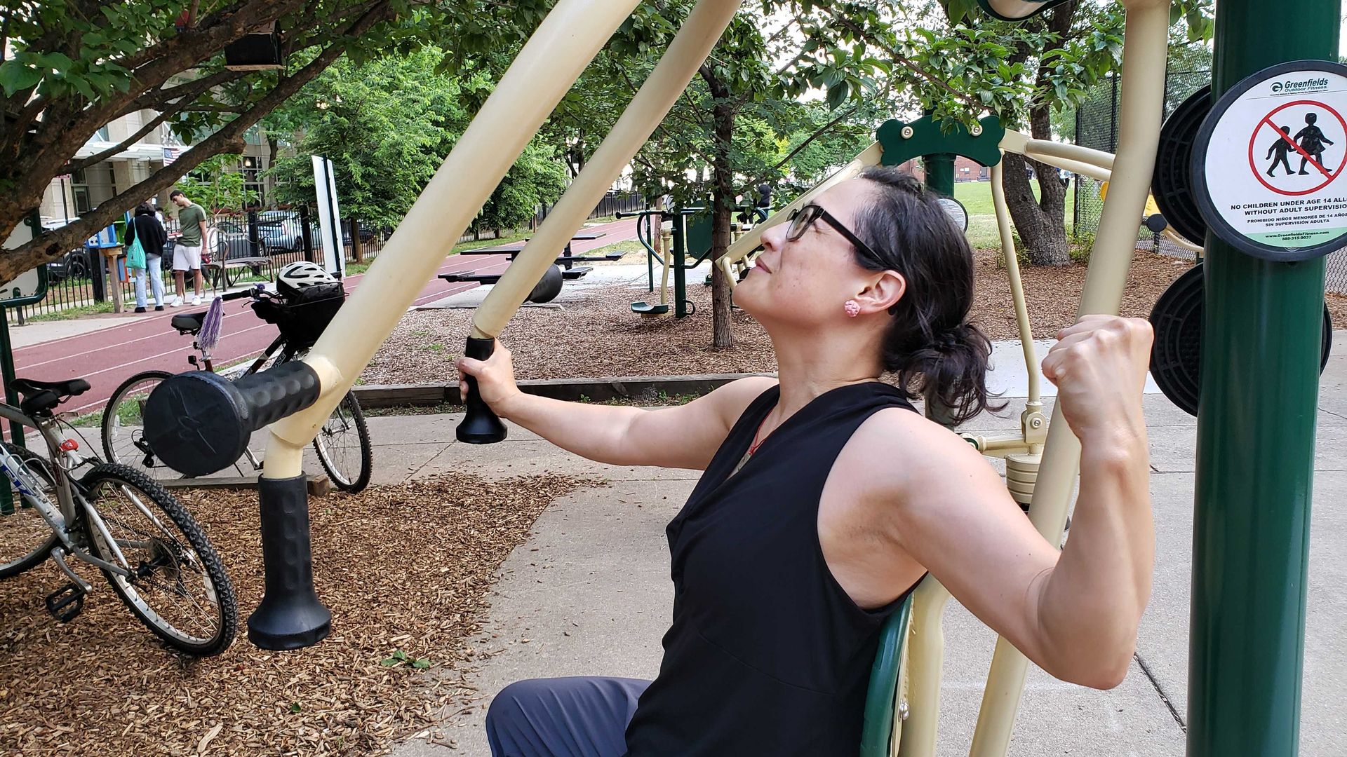 Woman on a weight lifting machine in the park 
