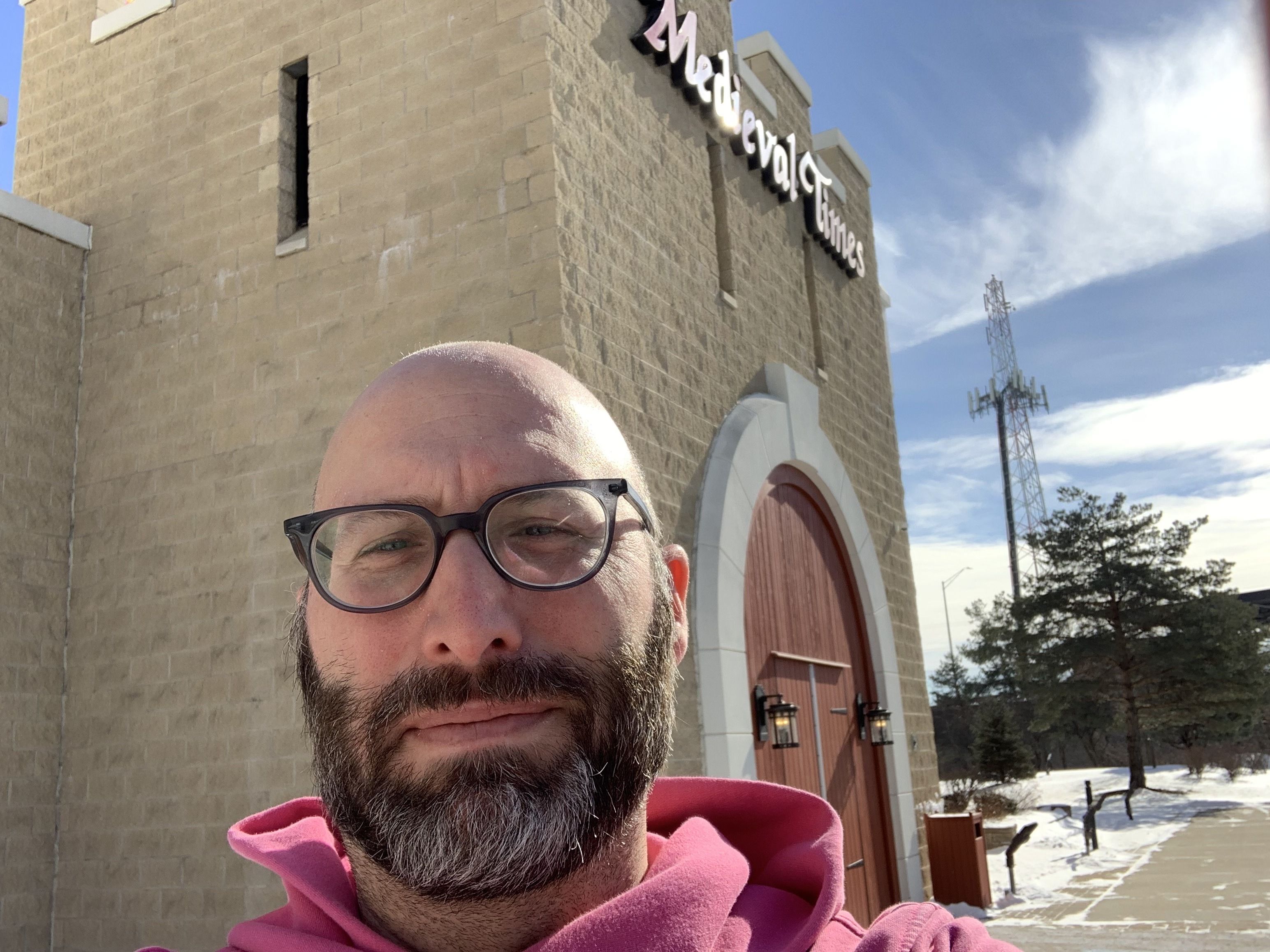 Photo of a man in front of a castle.