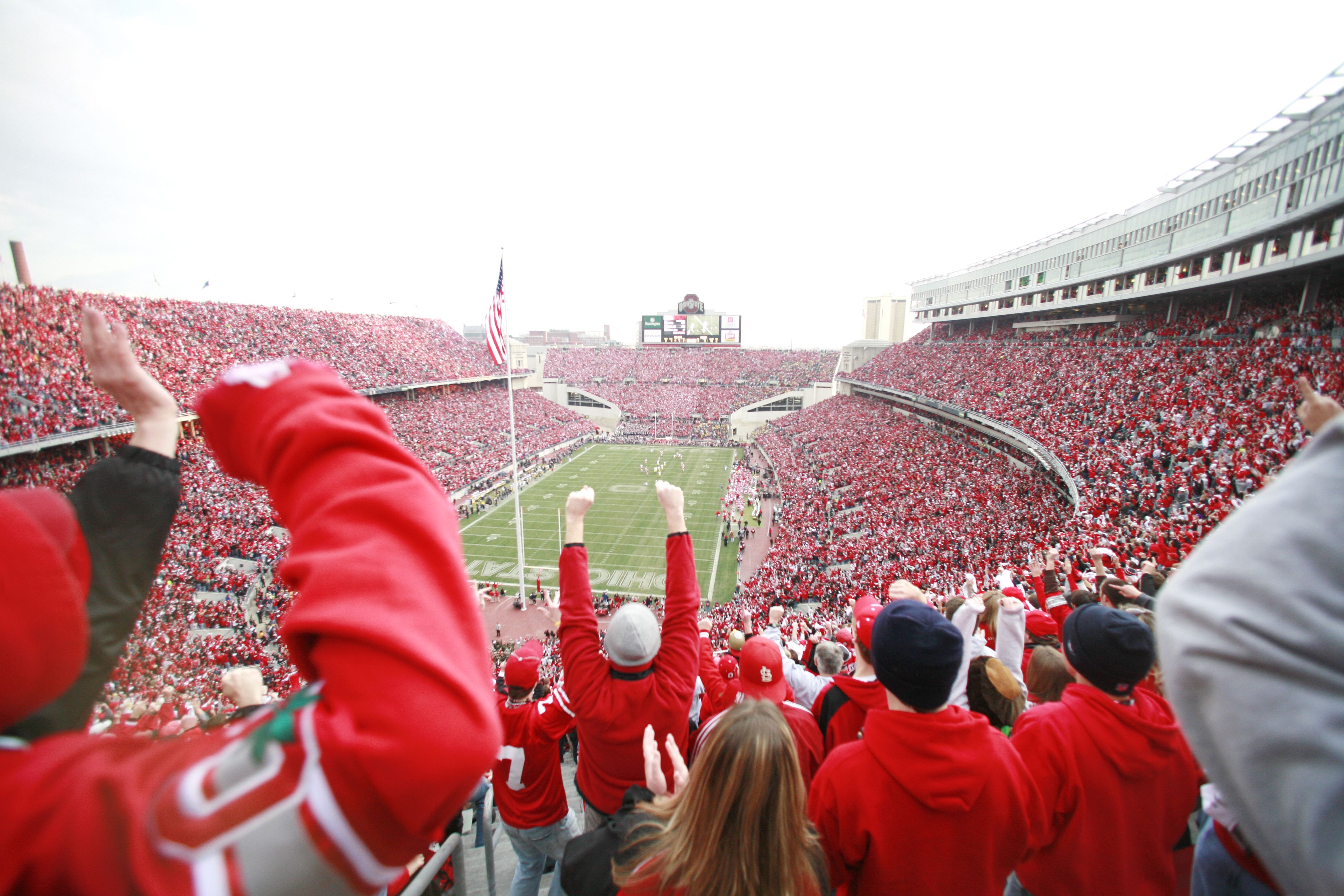 Fans cheer during an Ohio State football game in a stadium panorama shot. 