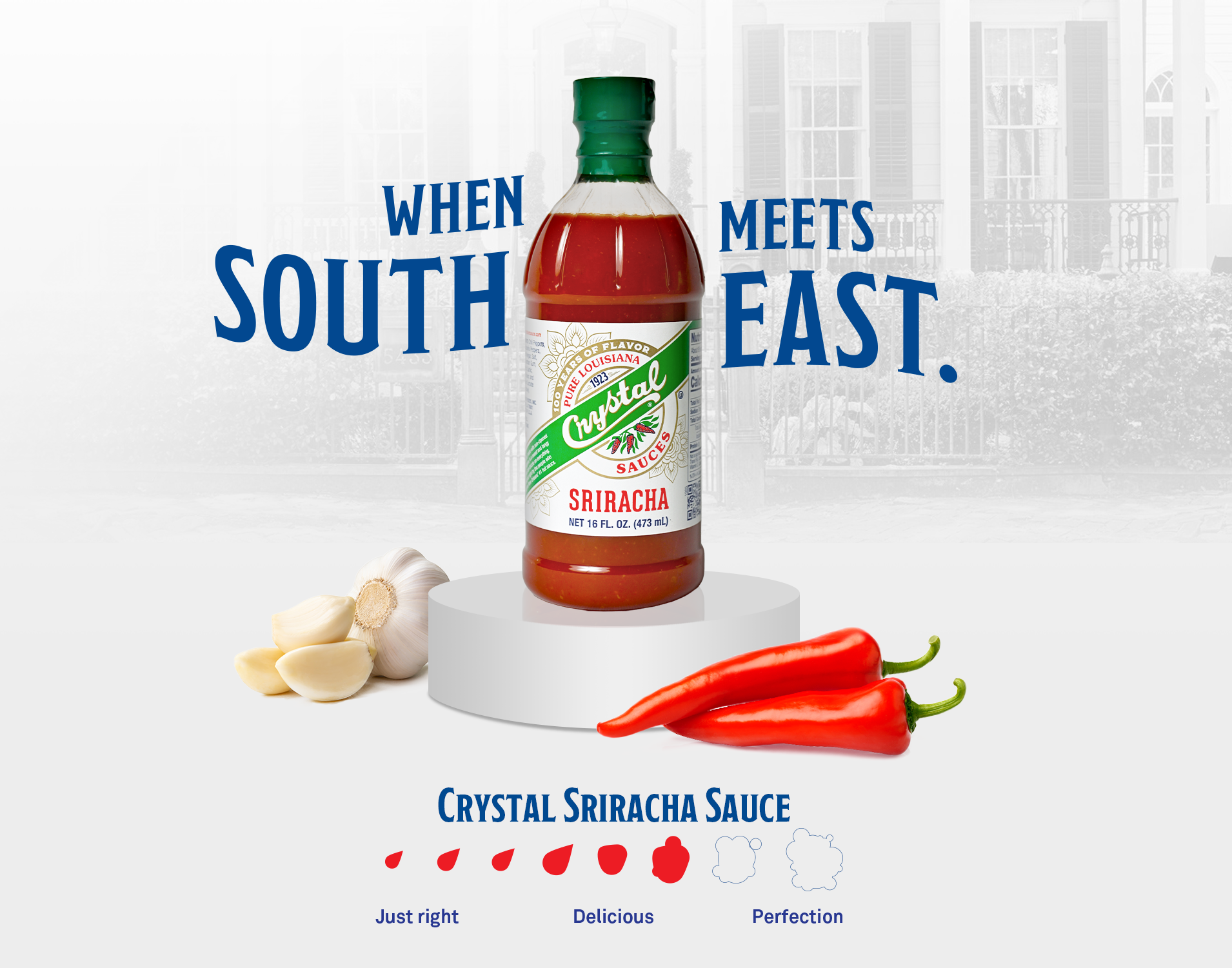 Bottle of Crystal Sriracha Sauce on a white pedestal with garlic and red chili peppers nearby; text says "When South meets East" and rating drops labeled Just right, Delicious, Perfection.