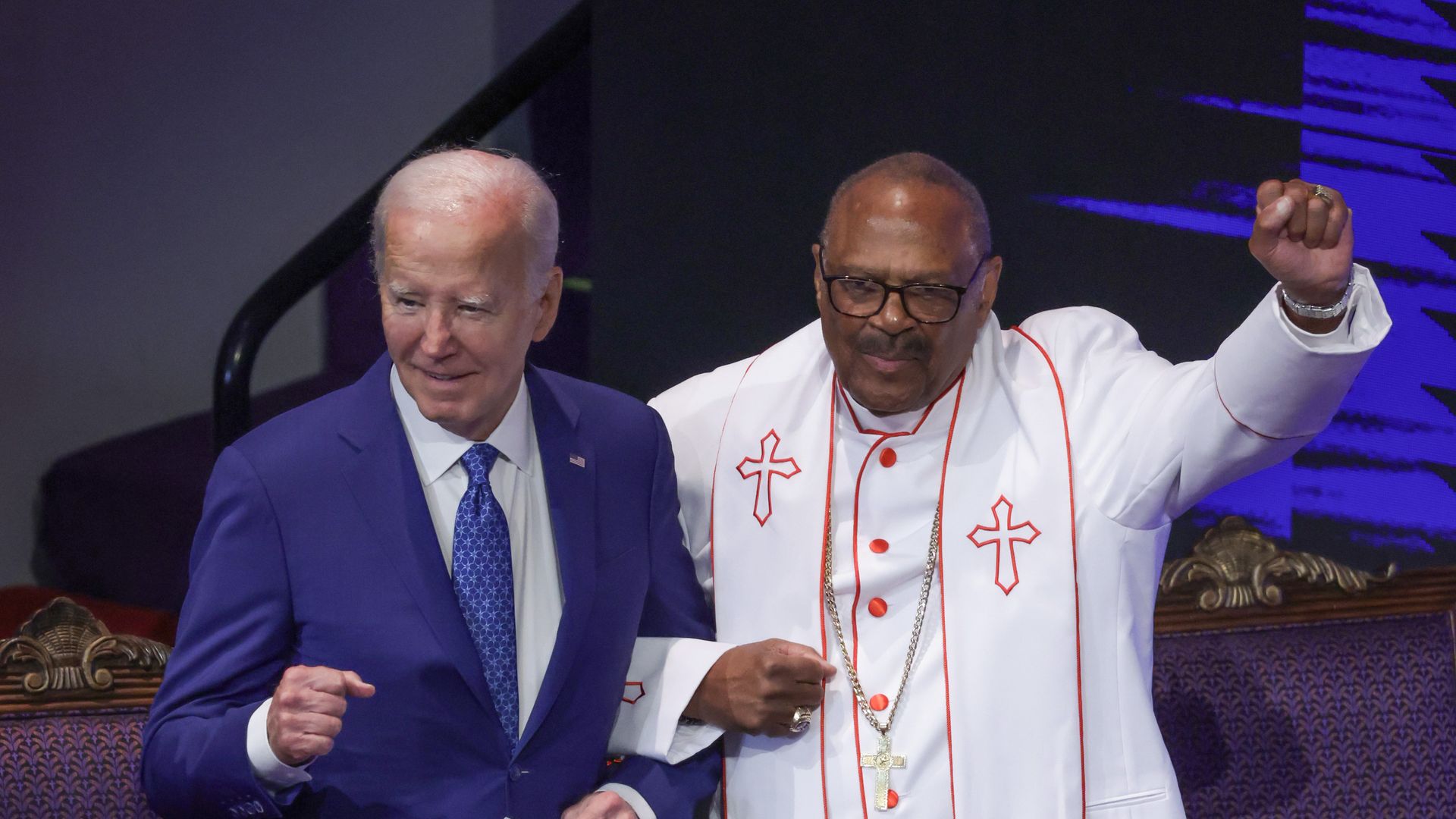 Biden on a church stage with a Black pastor in his vestments