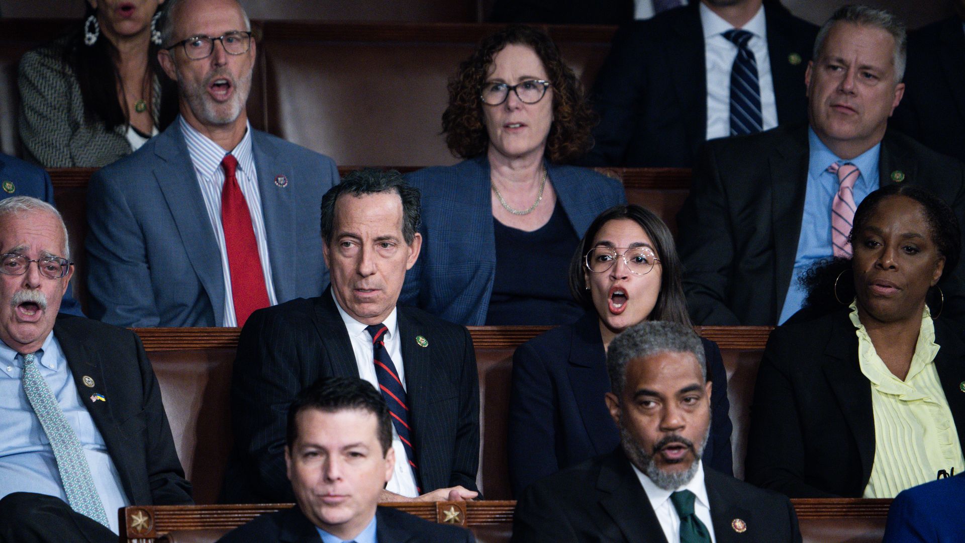 House Democrats seated in the House chamber, with several yelling.