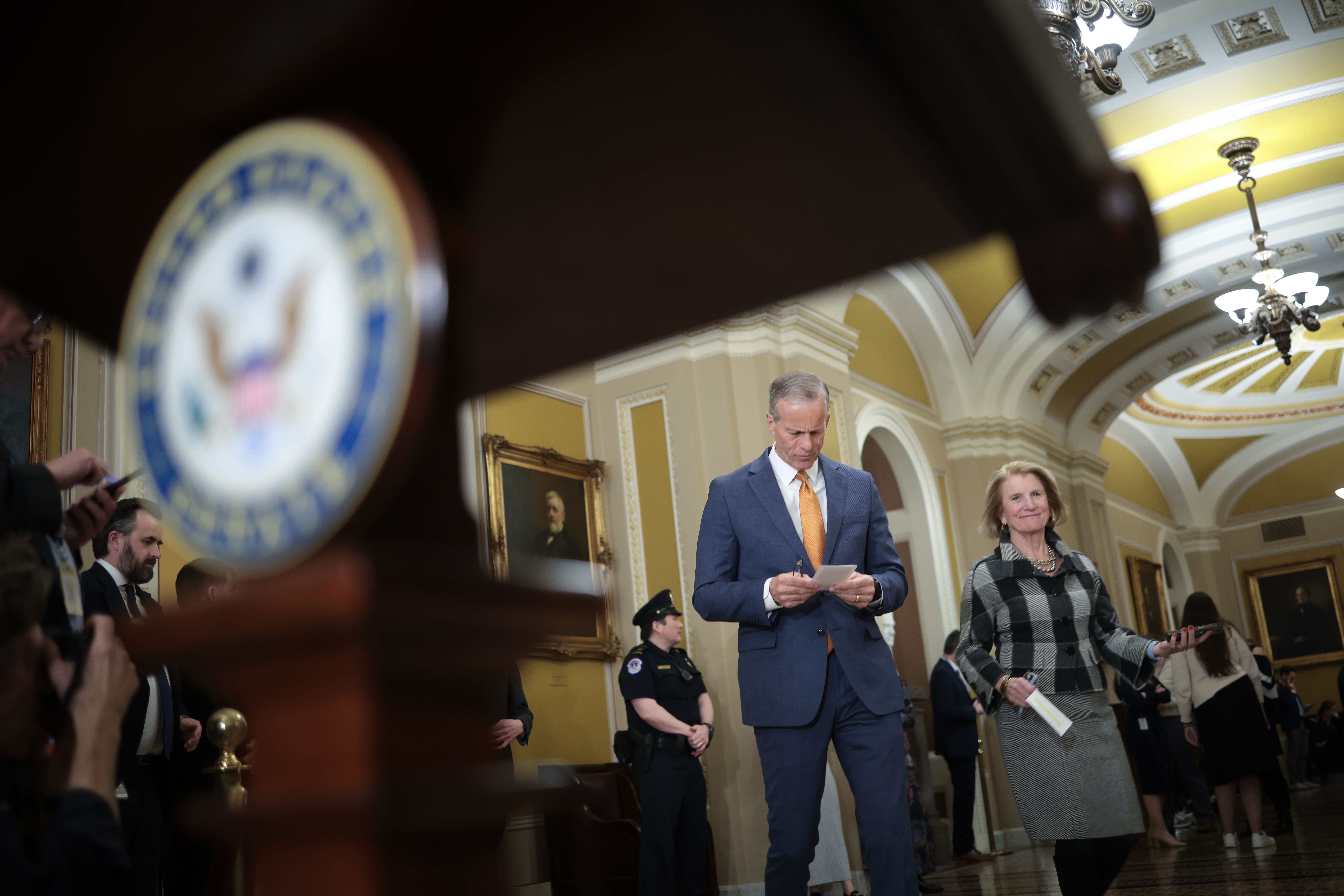 Senate Majority Leader John Thune (R-S.D.) walks to a podium to deliver remarks with Sen. Shelley Moore Capito (R-W.Va.) at the U.S. Capitol following a weekly Republican policy luncheon on Feb. 4, 2025.