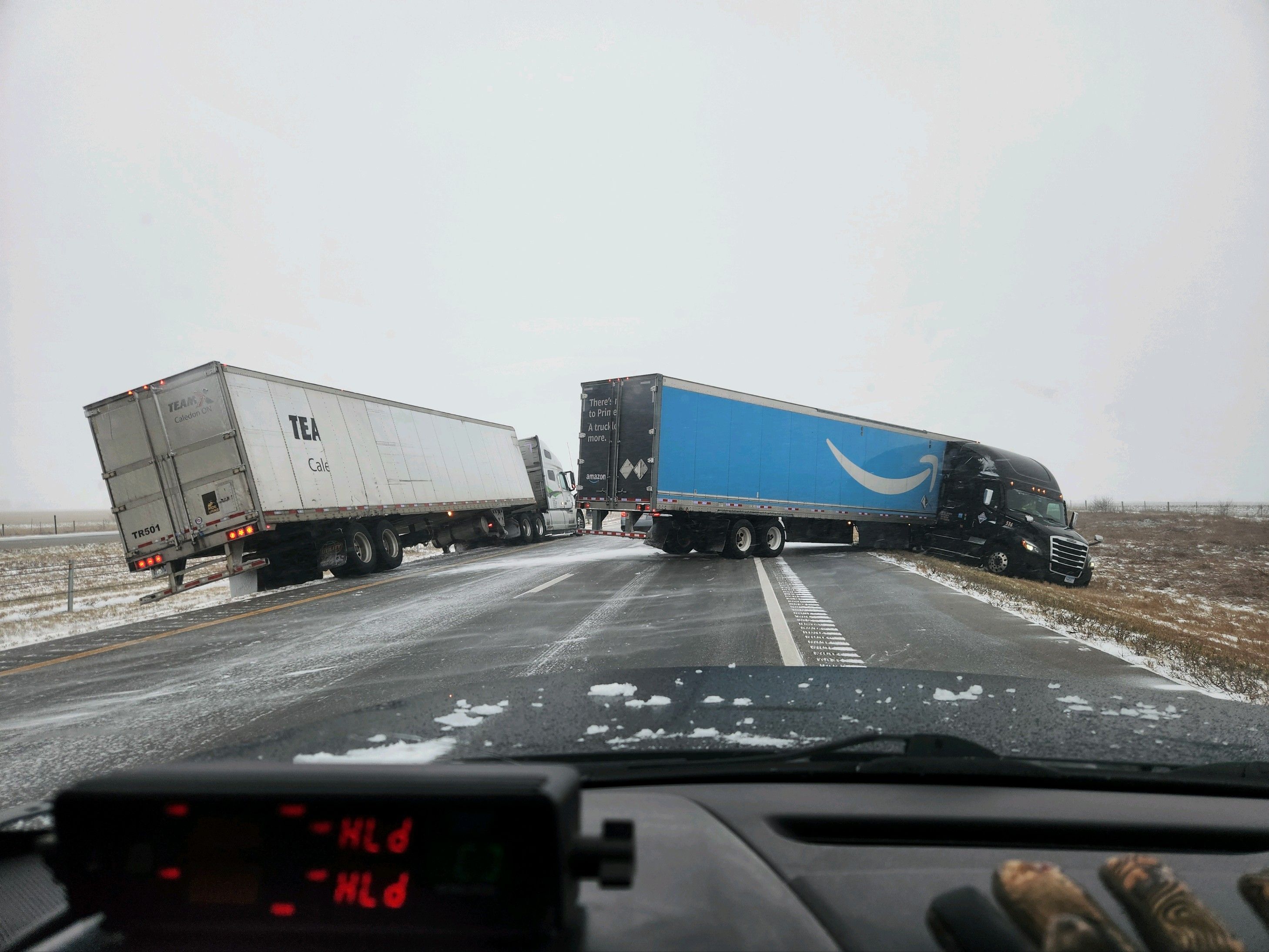 Trucks that skidded off the highway