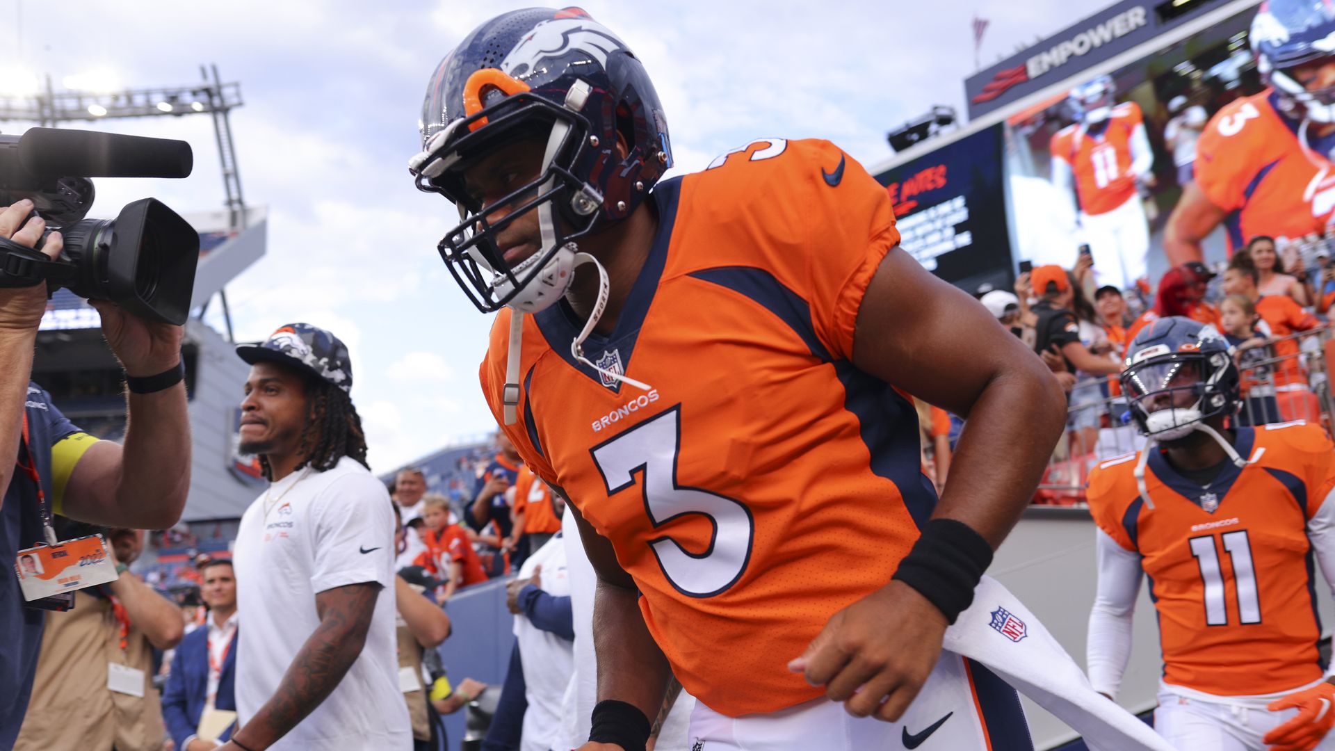 Russell Wilson #3 of the Denver Broncos runs onto the field for warm-up before the game against the Dallas Cowboys at Empower Field At Mile High on August 13, 2022 in Denver, Colorado. 