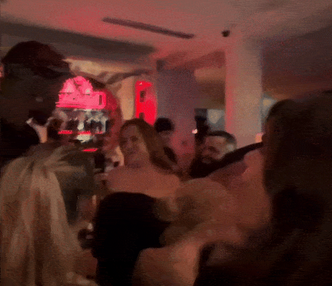 Axios Miami's Sommer Brugal hugs Heat player Jimmy Butler during an event. 