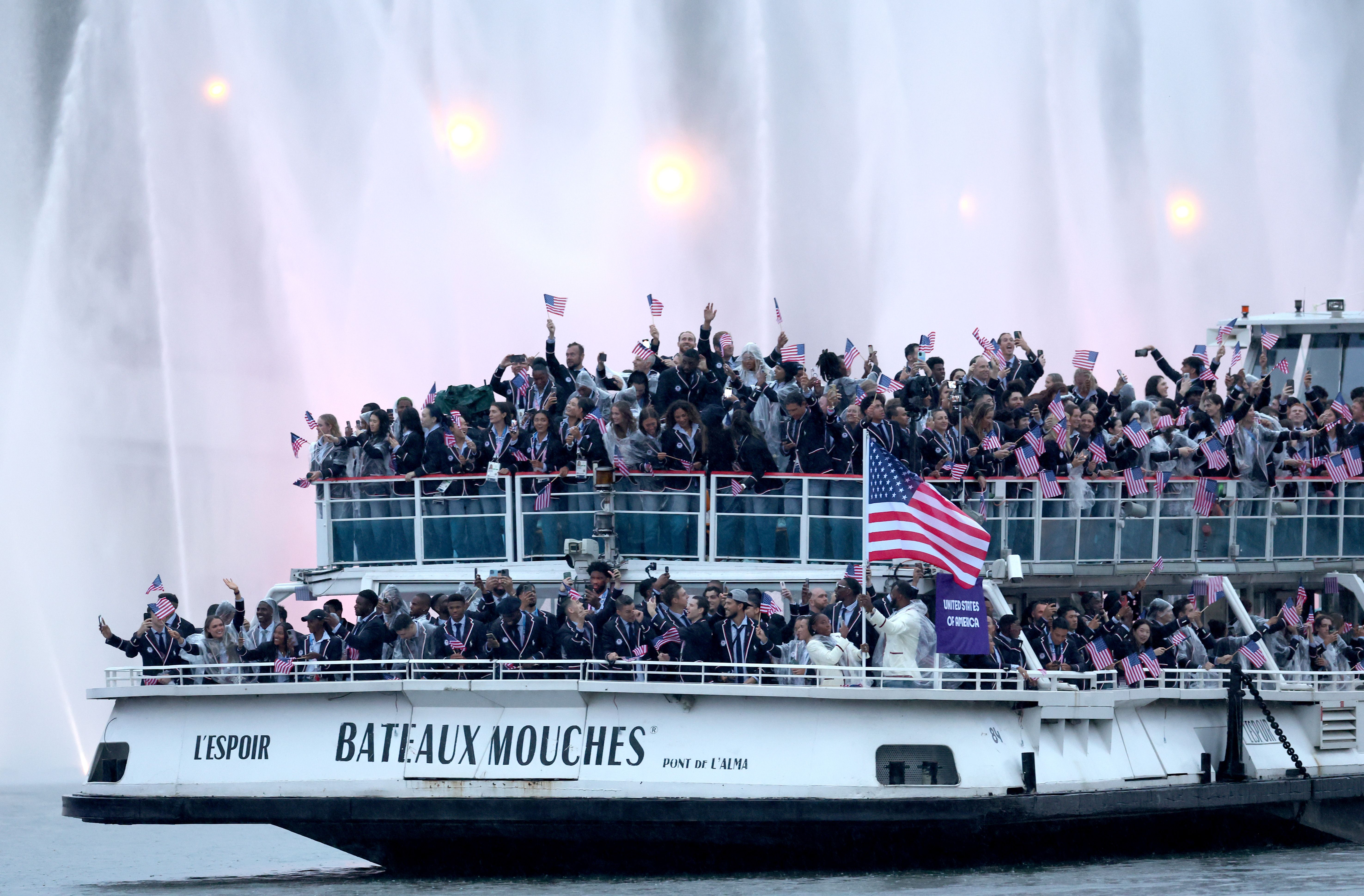 A general view as Members of Team United States pass water jets after going through the water curtain under the Austerlitz Bridge (not pictured) on the River Seine during the opening ceremony of the Olympic Games Paris 2024 on July 26, 2024 in Paris, France. (Photo by Maja Hitij/Getty Images)