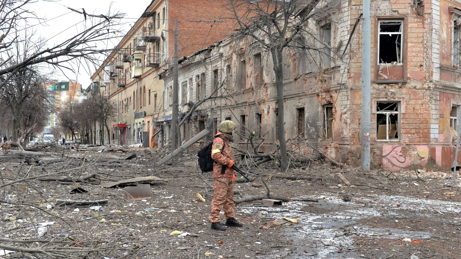 A member of the Ukrainian Territorial Defence Forces looks at destructions following a shelling in Ukraine's second-biggest city of Kharkiv on March 7, 2022