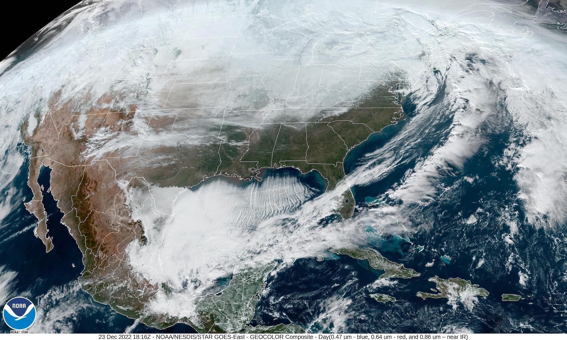 A satellite image showing an arctic outbreak and a bomb cyclone over North America.