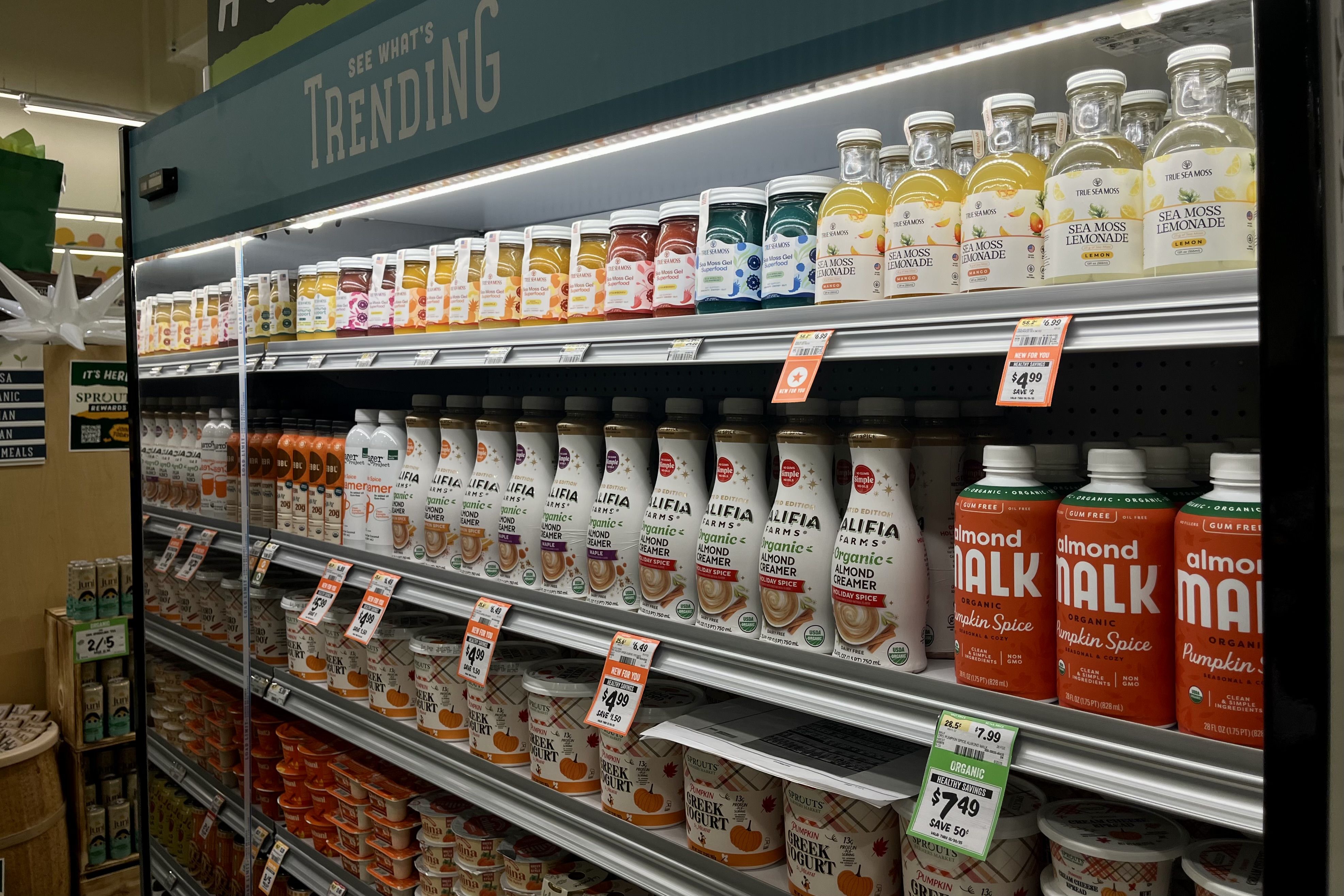 Grocery store shelf labeled "See What's Trending" with rows of colorful bottles and containers.