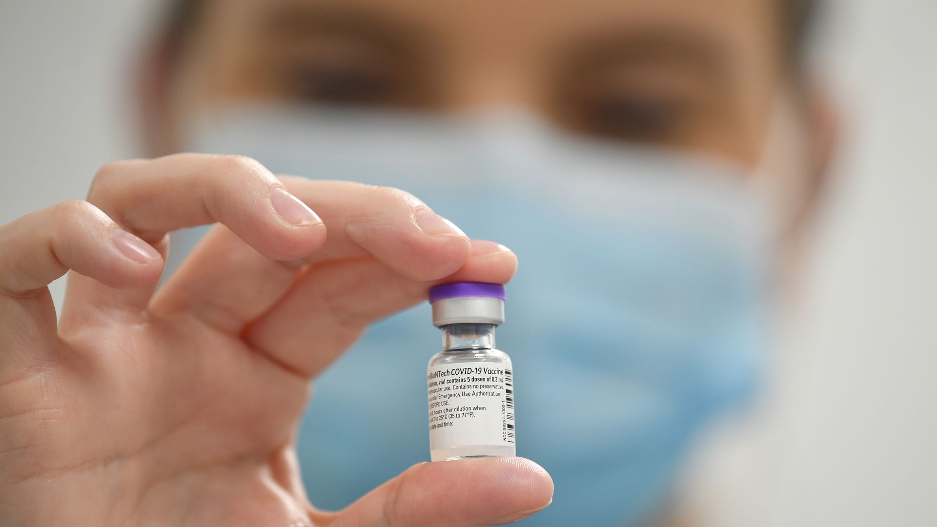 A member of staff poses with a phial of Pfizer-BioNTech Covid-19 vaccine at a vaccination health center on December 8, 2020 in Cardiff, United Kingdom.