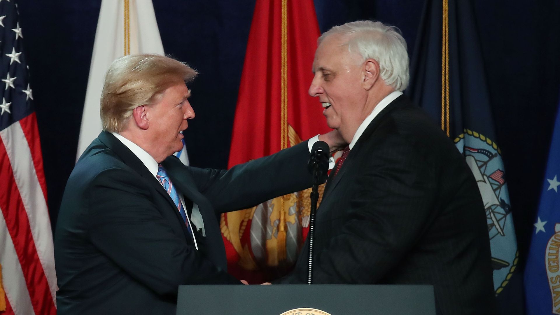 This is a photo of Jim Justice shaking hands with Donald Trump 